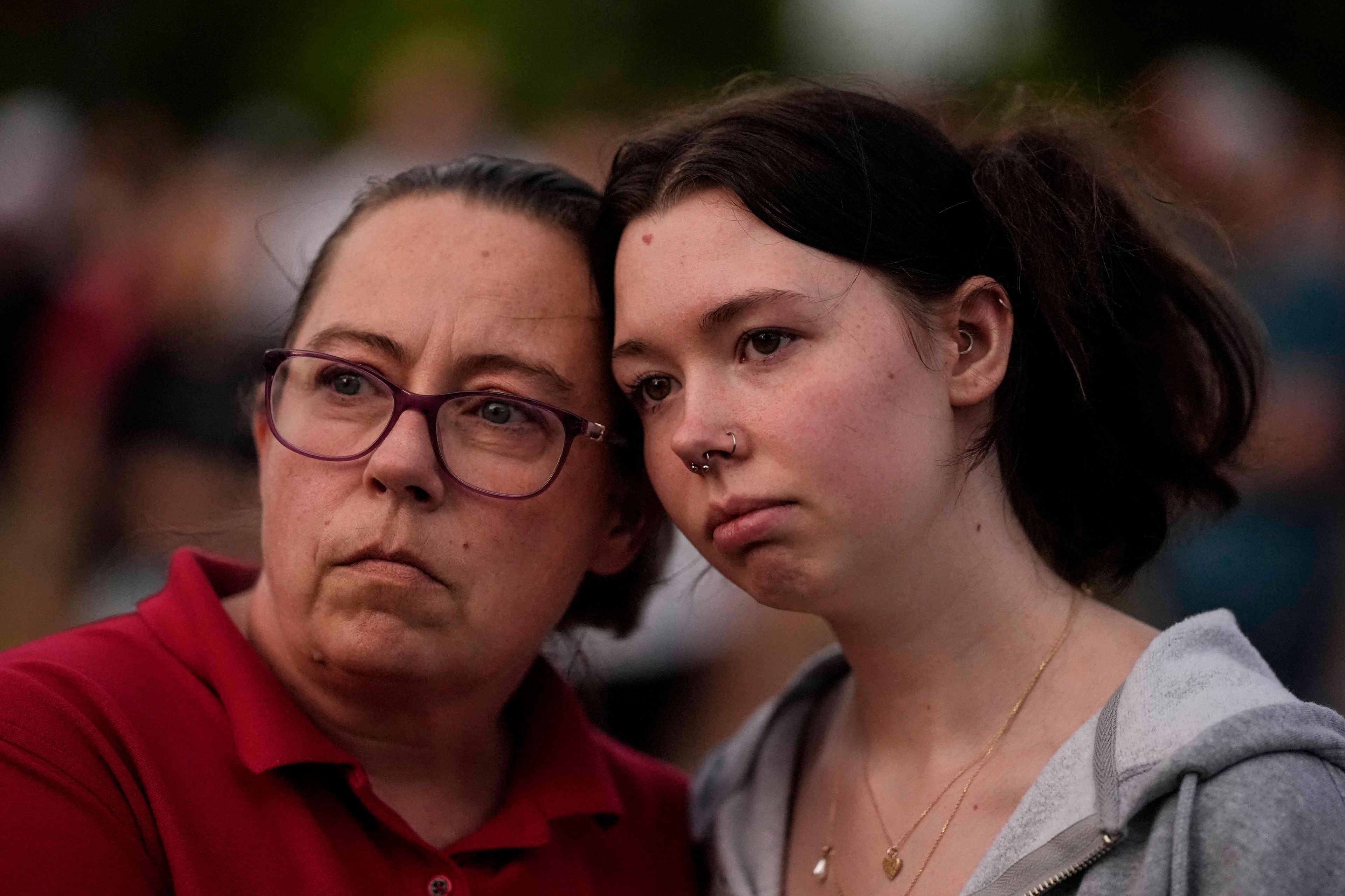 Mourners hold candles during a candlelight vigil for the slain students and teachers at Apalachee High School, Wednesday, Sept. 4, 2024, in Winder, Ga. (AP Photo/Mike Stewart)