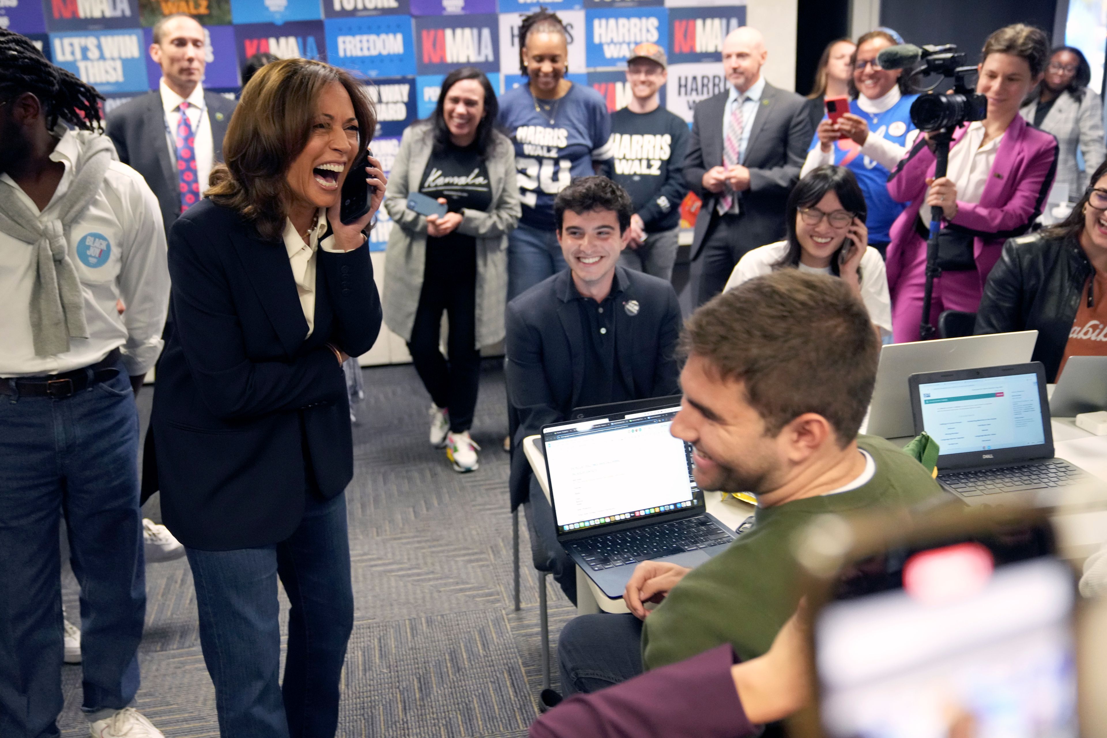 Democratic presidential nominee Vice President Kamala Harris, left, reacts as she phone banks with volunteers at the DNC headquarters on Election Day, Tuesday, Nov. 5, 2024, in Washington. (AP Photo/Jacquelyn Martin)