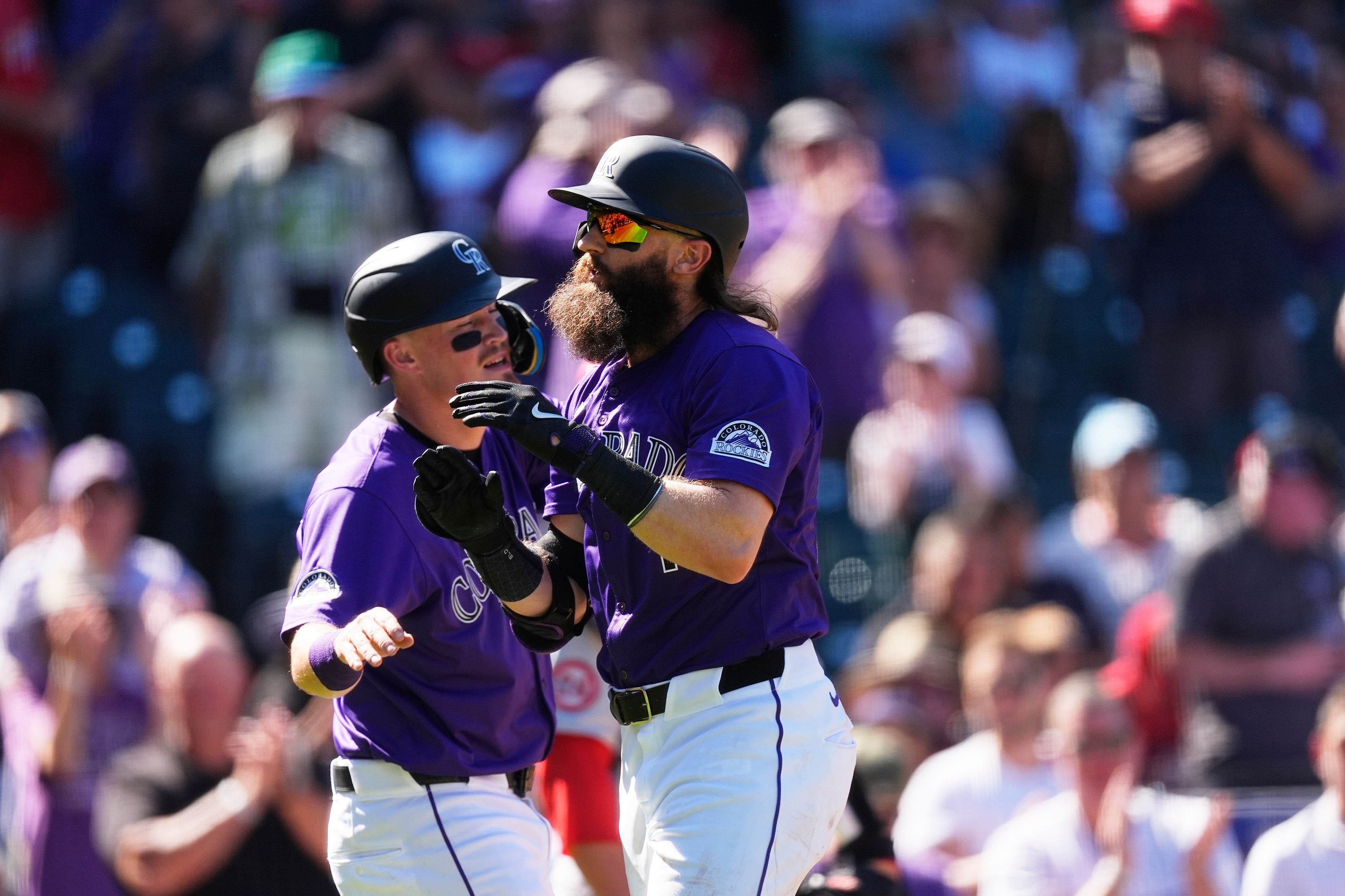 Colorado Rockies' Aaron Schunk, left, congratulates Charlie Blackmon as he crosses home plate after hitting a two-run home run off St. Louis Cardinals starting pitcher Kyle Gibson in second inning of a baseball game Thursday, Sept. 26, 2024, in Denver. (AP Photo/David Zalubowski)