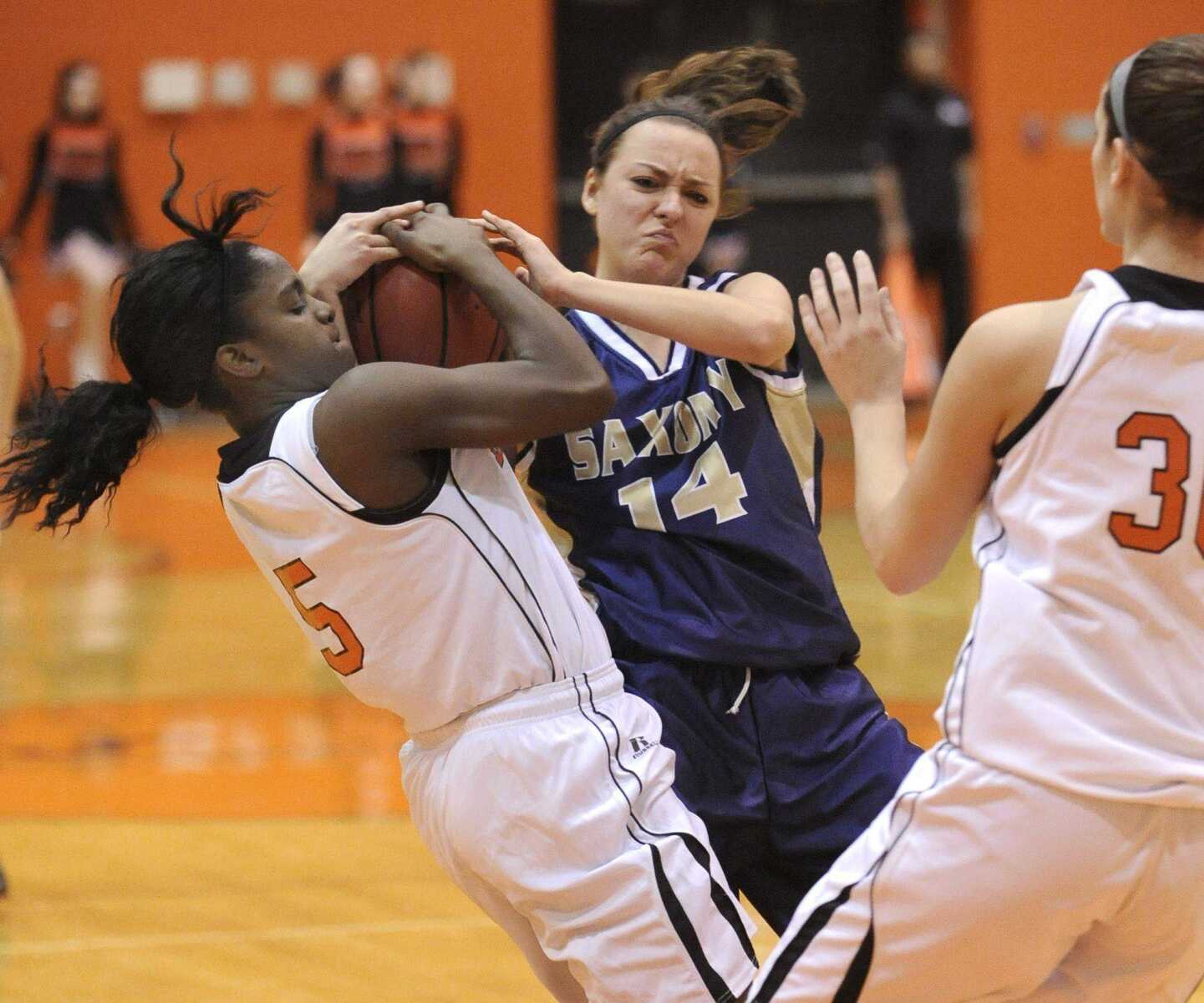 Central's Alayah Cooper-Johnson tries to steal the ball from Saxony Lutheran's Abby Hartmann during the first quarter Wednesday. (Fred Lynch)