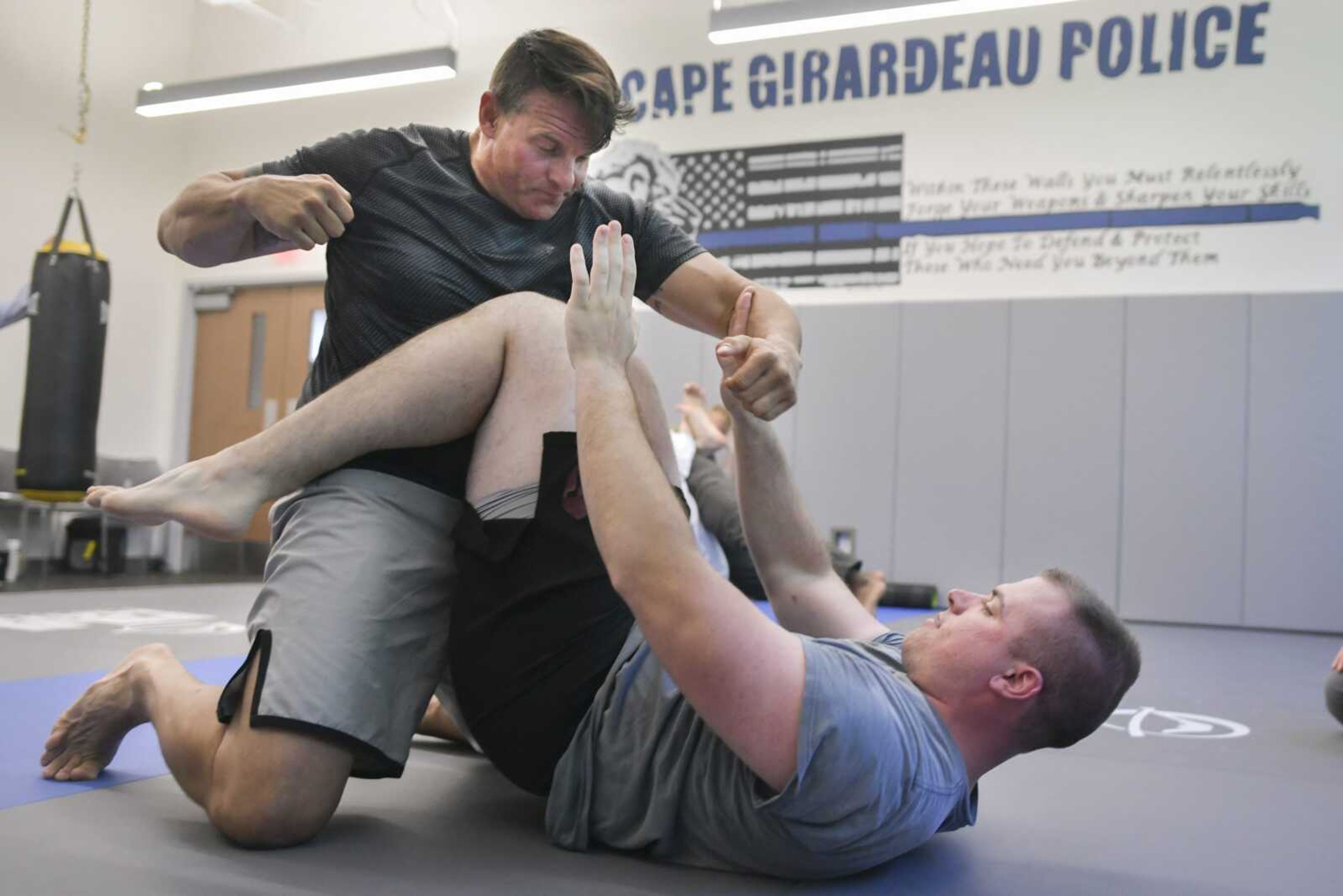 Cape Girardeau police Sgt. Joey Hann acts as an attacker as patrolman Jacob Monteith practices a self-defense technique Wednesday at the Cape Girardeau Police Department in Cape Girardeau.