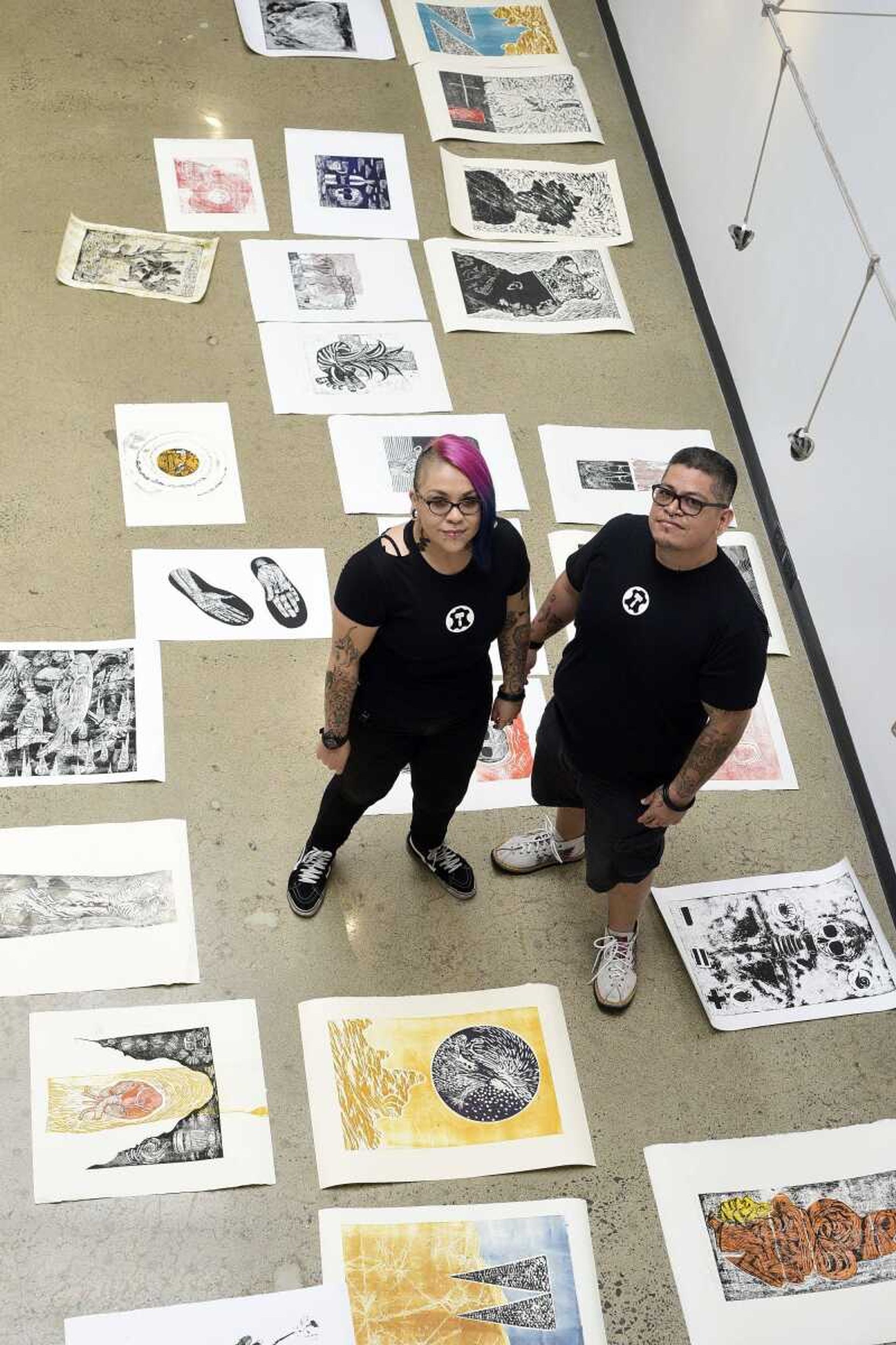 Alejandra Mares, left, and her husband, Xavier Moreno, pose for a photo before hanging artwork for an upcoming show at Catapult Creative House in Cape Girardeau.