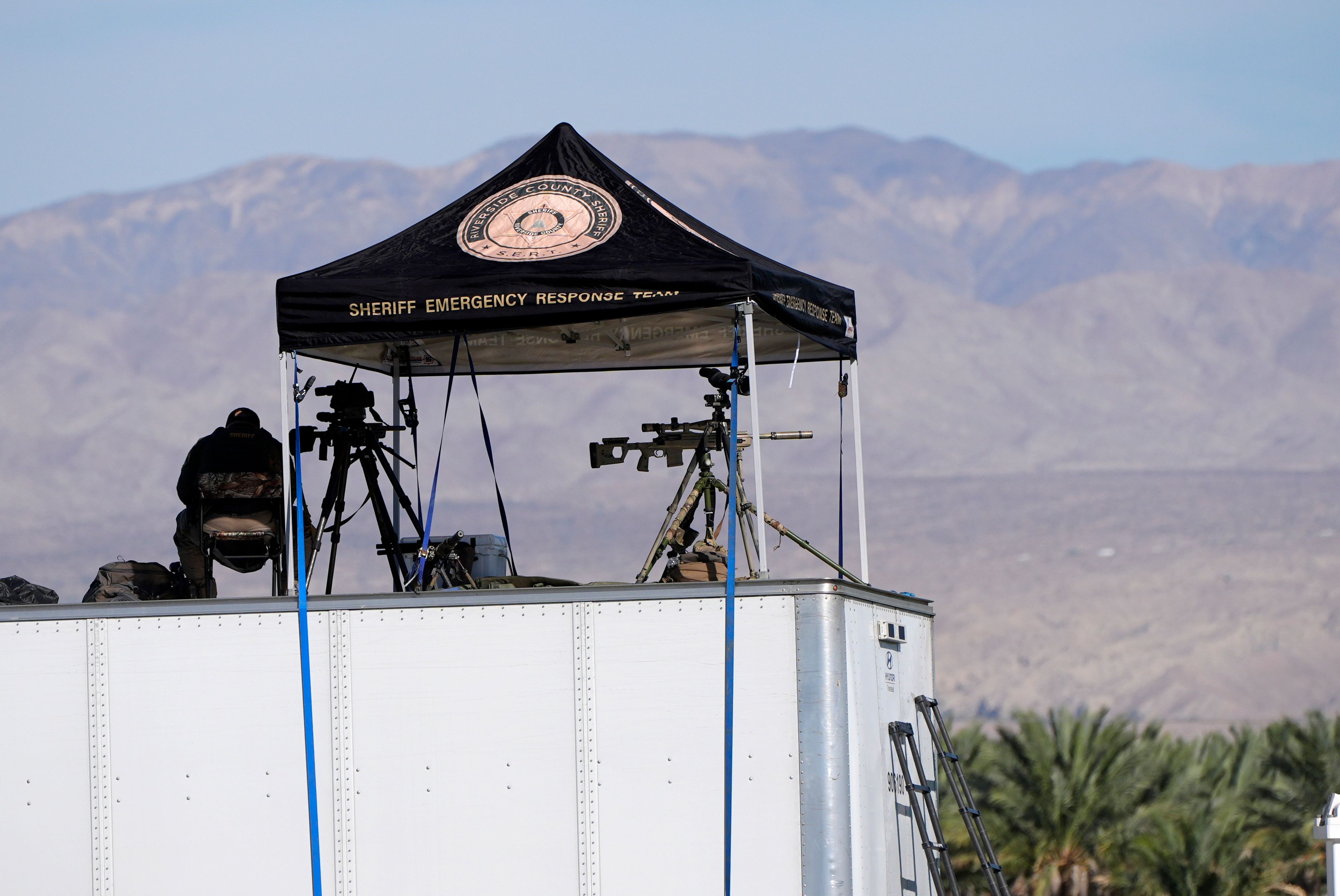 Law enforcement snipers look over the scene before Republican presidential nominee former President Donald Trump speaks at a campaign rally at the Calhoun Ranch, Saturday, Oct. 12, 2024, in Coachella, Calif. (AP Photo/Alex Brandon)