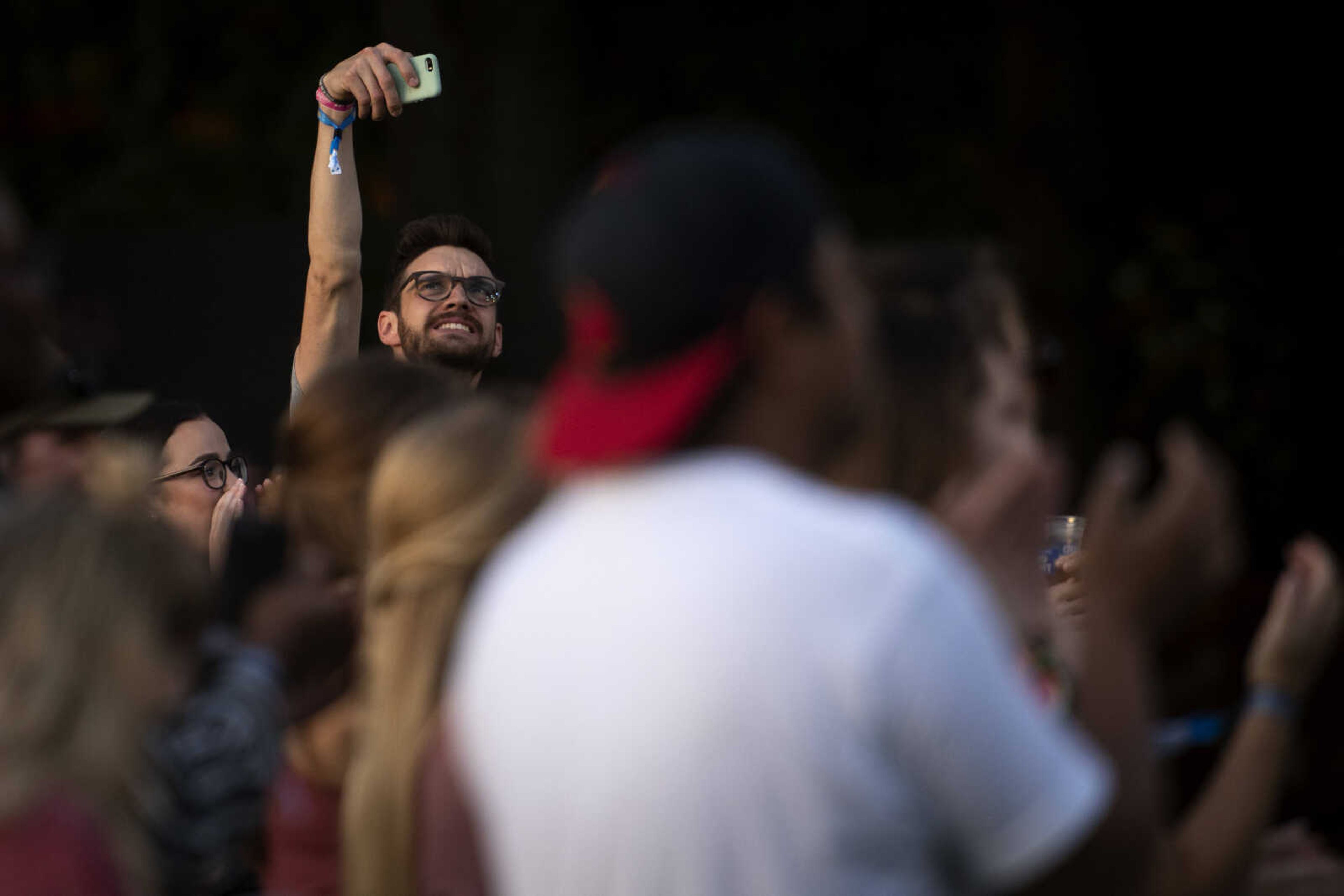 Amos Golling, of Magdeburg, Germany, holds a phone above the crowd during Shipyard Music and Culture Festival on Friday, Sept. 27, 2019, in Cape Girardeau.