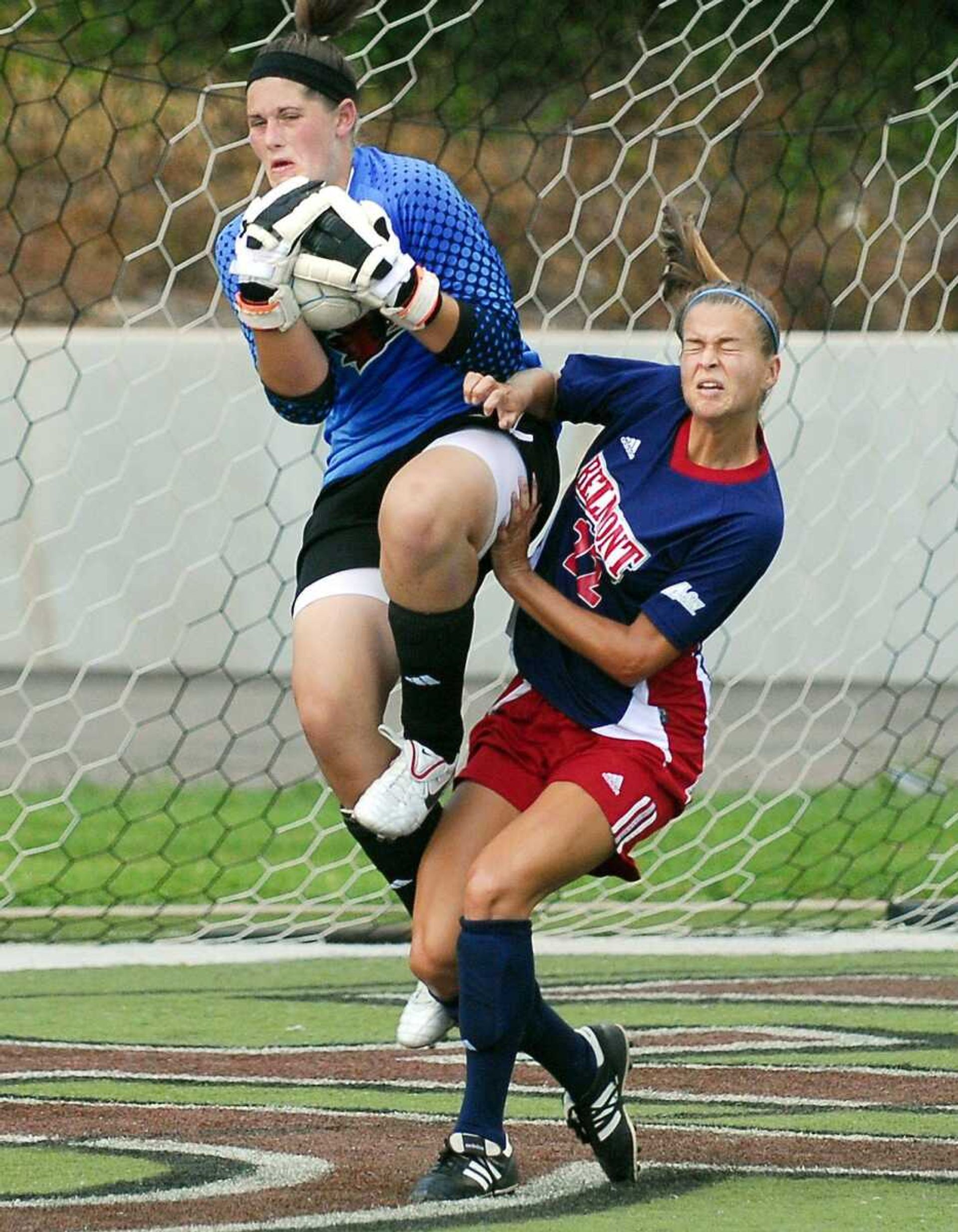 Southeast Missouri State goalkeeper Ashton Aubuchon makes a save while fending off Belmont's Madison Porter.