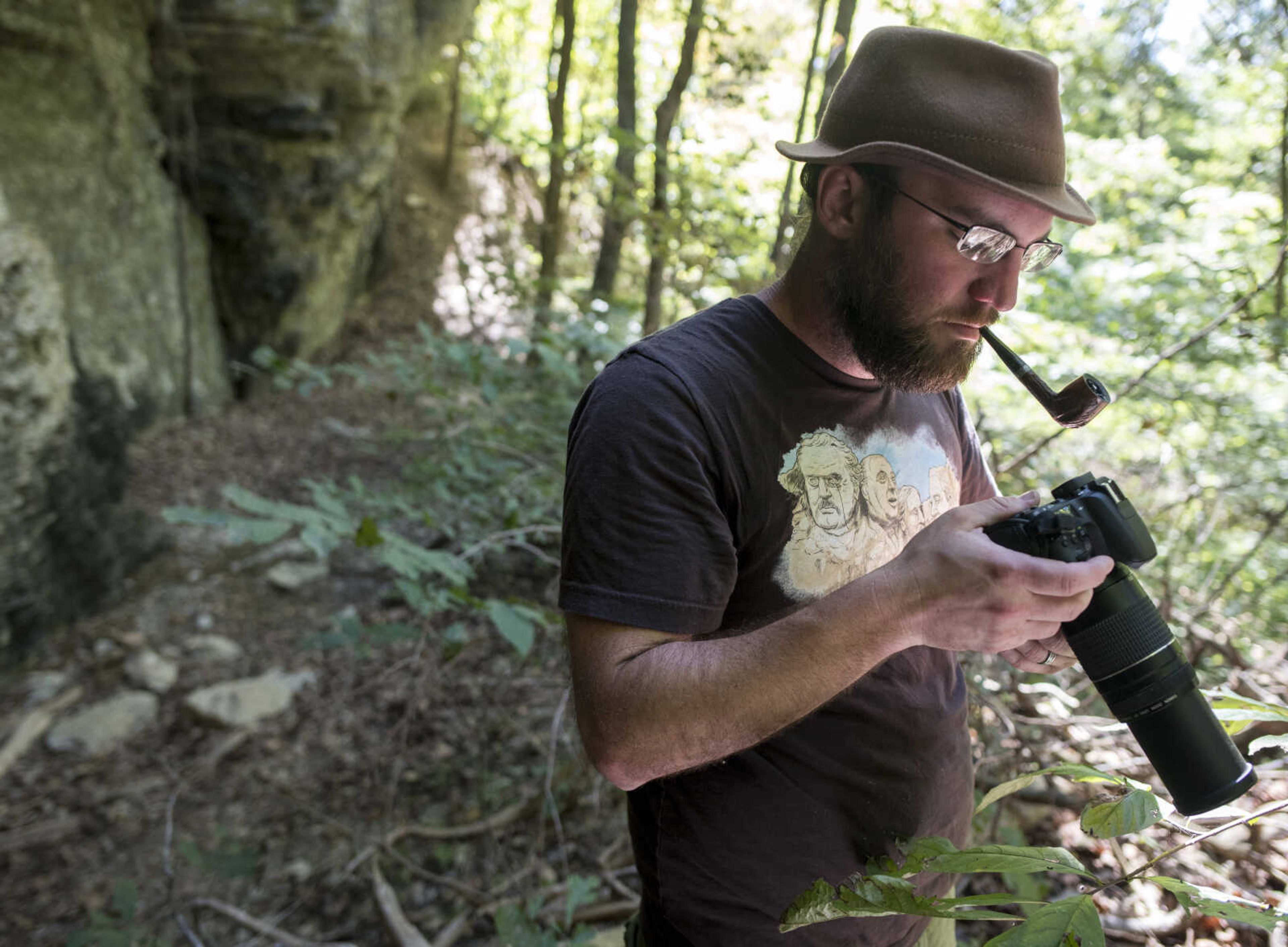 Montreat College environmental science instructor Joshua Holbrook views an eastern red bat Saturday, Oct. 5, 2019, at Snake Road in Wolf Lake, Illinois.