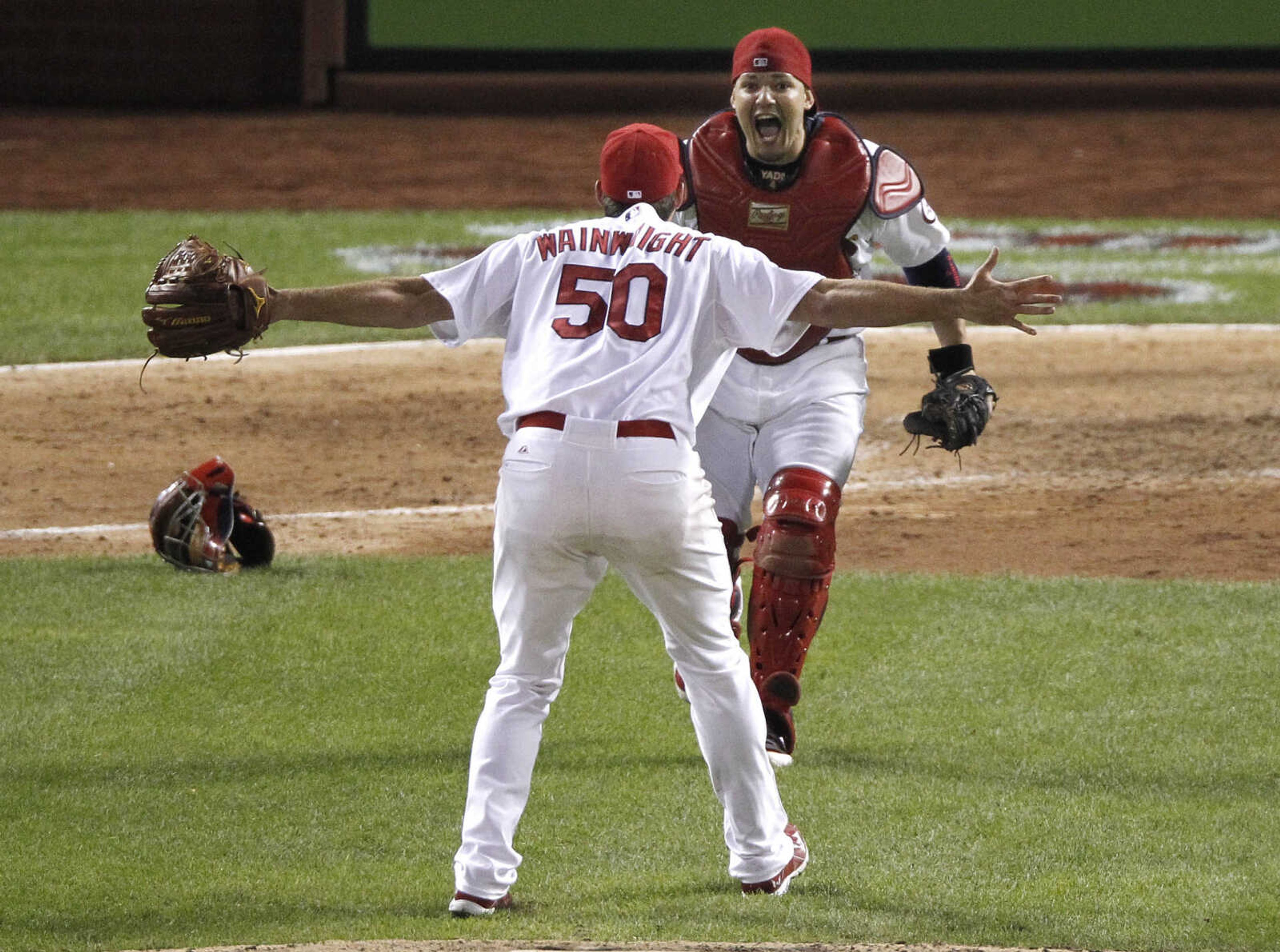 St. Louis Cardinals pitcher Adam Wainwright (50) celebrates with catcher Yadier Molina after Wainwright struck out Pittsburgh Pirates' Pedro Alvarez in the ninth inning to win Game 5 of a National League baseball division series, Wednesday, Oct. 9, 2013, in St. Louis. The Cardinals won 6-1, and advanced to the NL championship series against the Los Angeles Dodgers. (AP Photo/Sarah Conard)