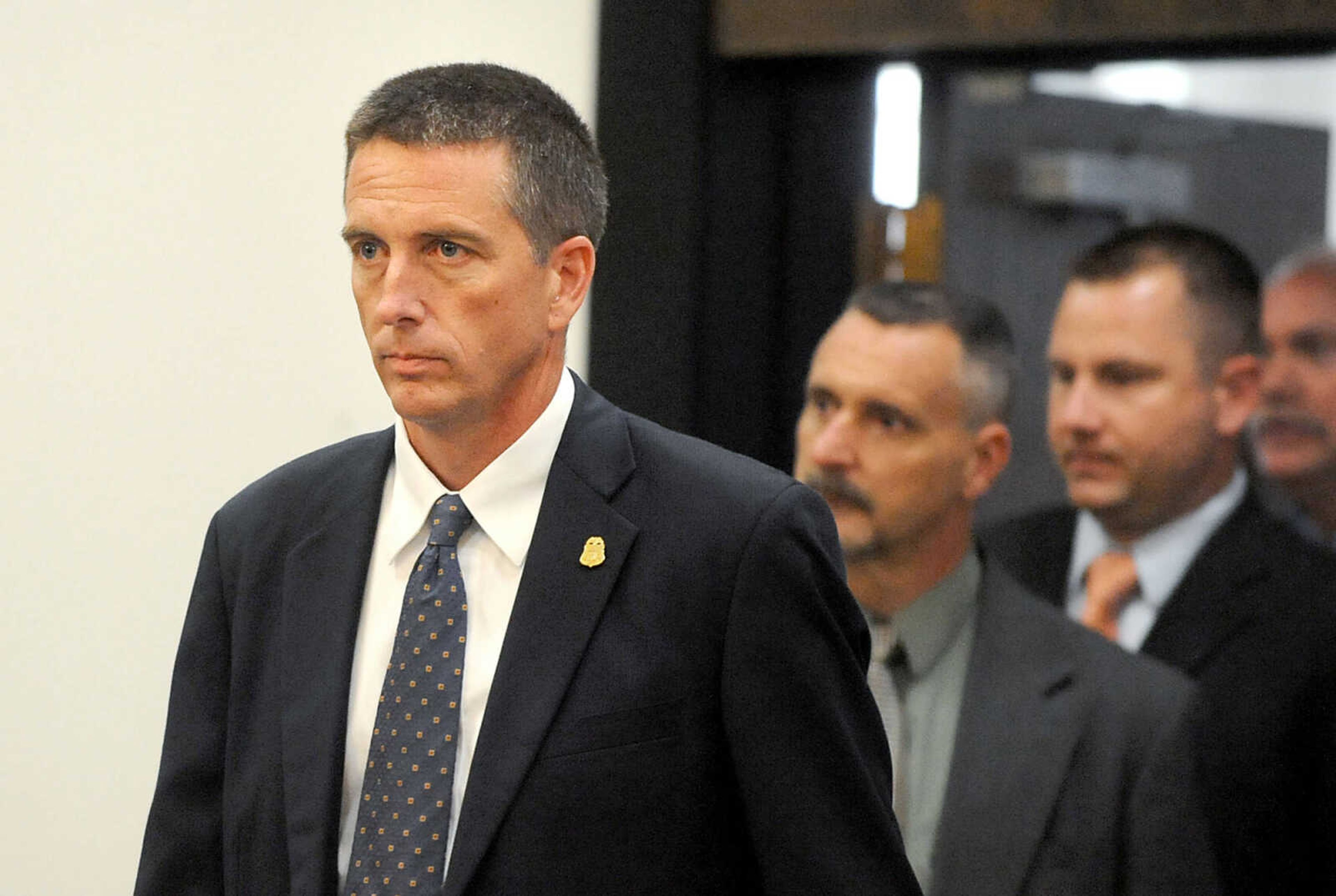 LAURA SIMON ~ lsimon@semissourian.com 
FBI agent Brian W. Ritter enters the courtroom along with other law enforcement officials, Thursday, June 6, 2013, at the Cape Girardeau County Courthouse. Clay Waller pleaded guilty to second-degree murder for the death of his wife, Jacque Waller. Jacque Waller went missing June 1, 2011. Her body was found last Wednesday in Southern Illinois.