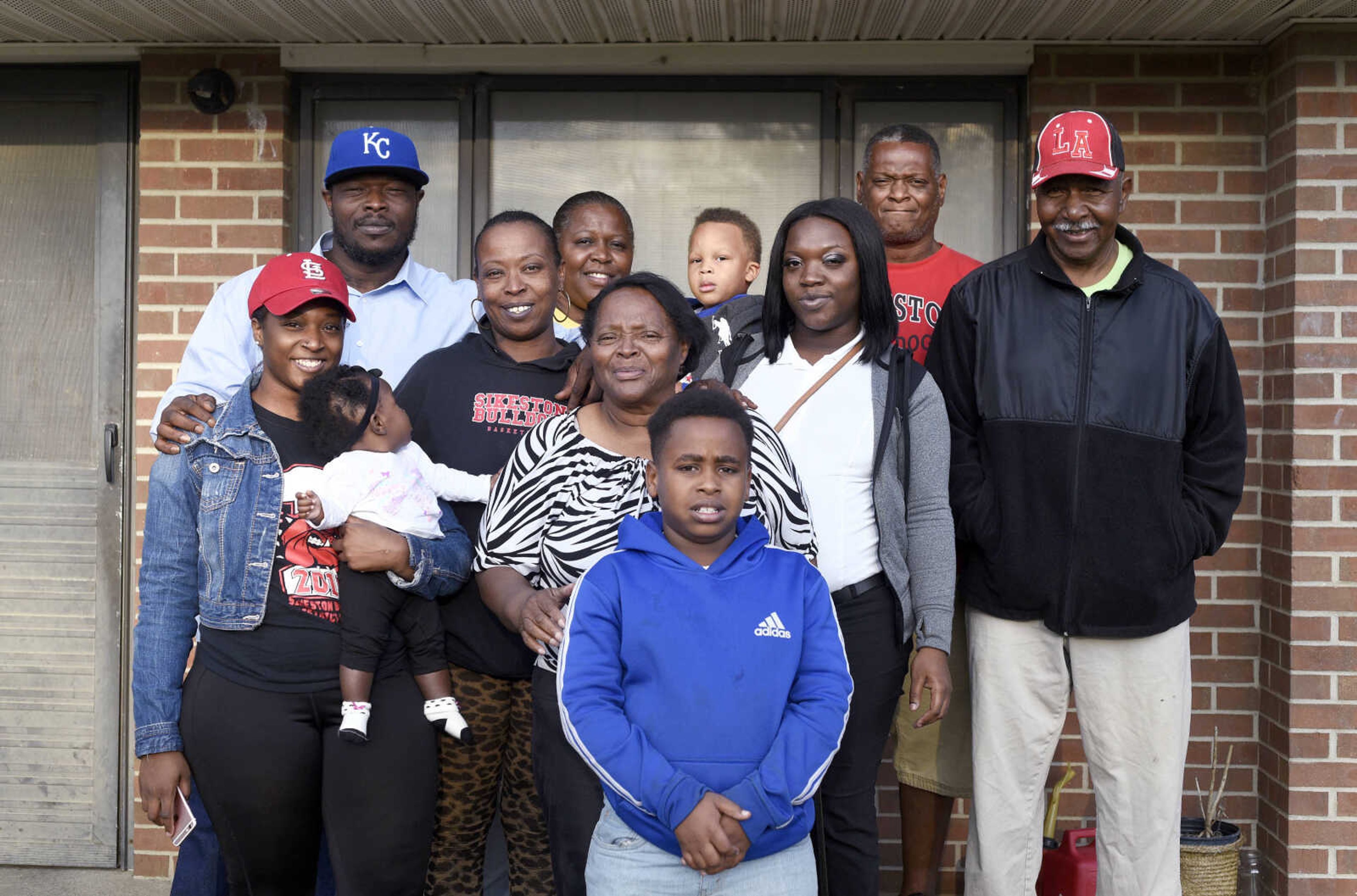 LAURA SIMON ~ lsimon@semissourian.com

David Robinson's family poses for a photo outside his mother's Sikeston, Missouri home in September. Pictured from left to right, back row, Justin Robinson, Bridgett Patterson, Kingston Patterson, 3, Marcus Robinson and Larry McClellon; Middle row, Jamia Robinson, then seven-month-old Justice Robinson, Monica Robinson, Jennett McCaster, Jamonica Robinson: front row, Maliek Patterson.