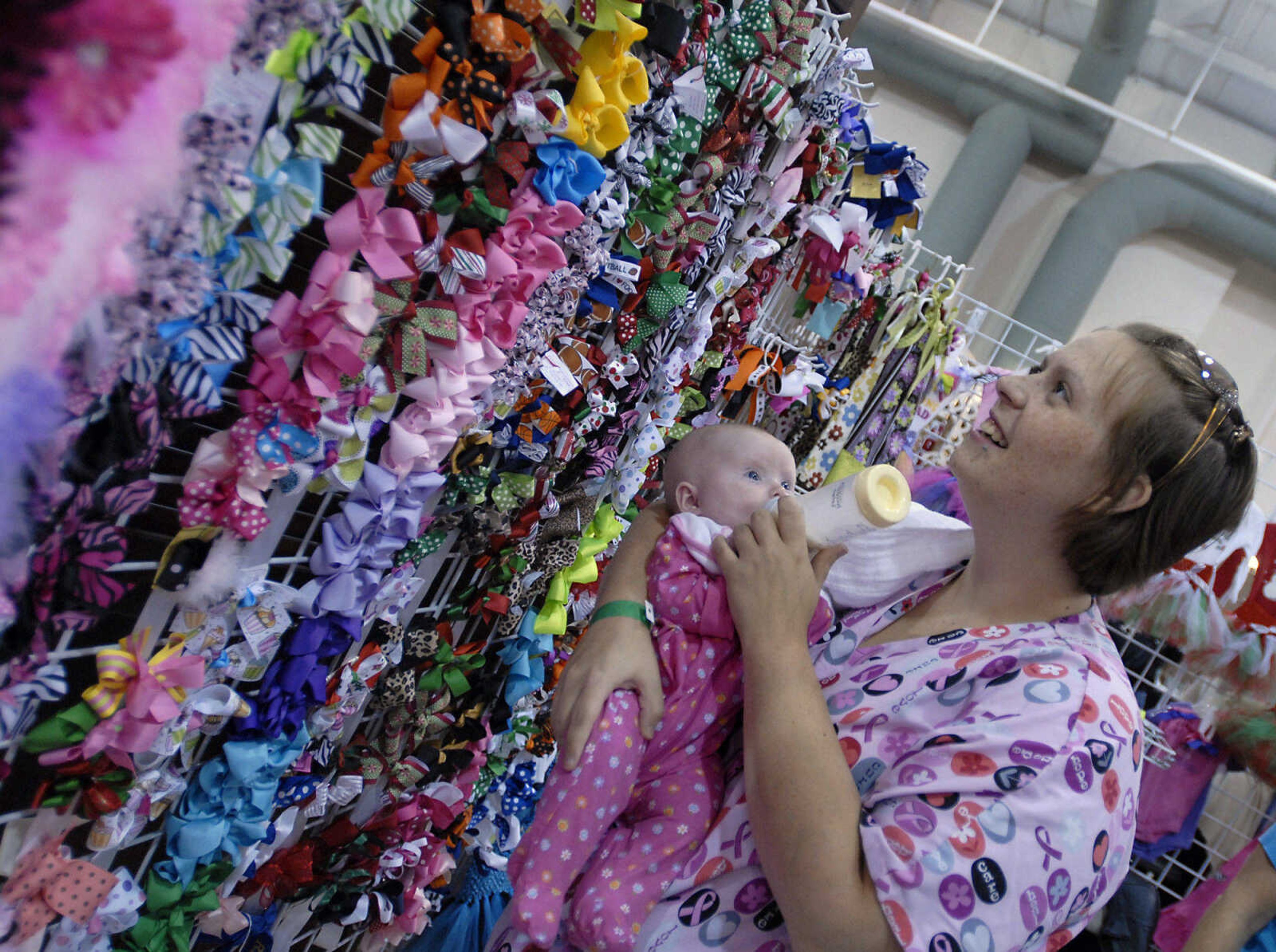 KRISTIN EBERTS ~ keberts@semissourian.com

Megan McKenzie looks for bows for her 3-month-old daughter, Coraline, at Linda Holst's "Bows & Bling" booth during the Arts and Crafts Extravaganza at the Osage Center in Cape Girardeau on Saturday, Nov. 19, 2011.