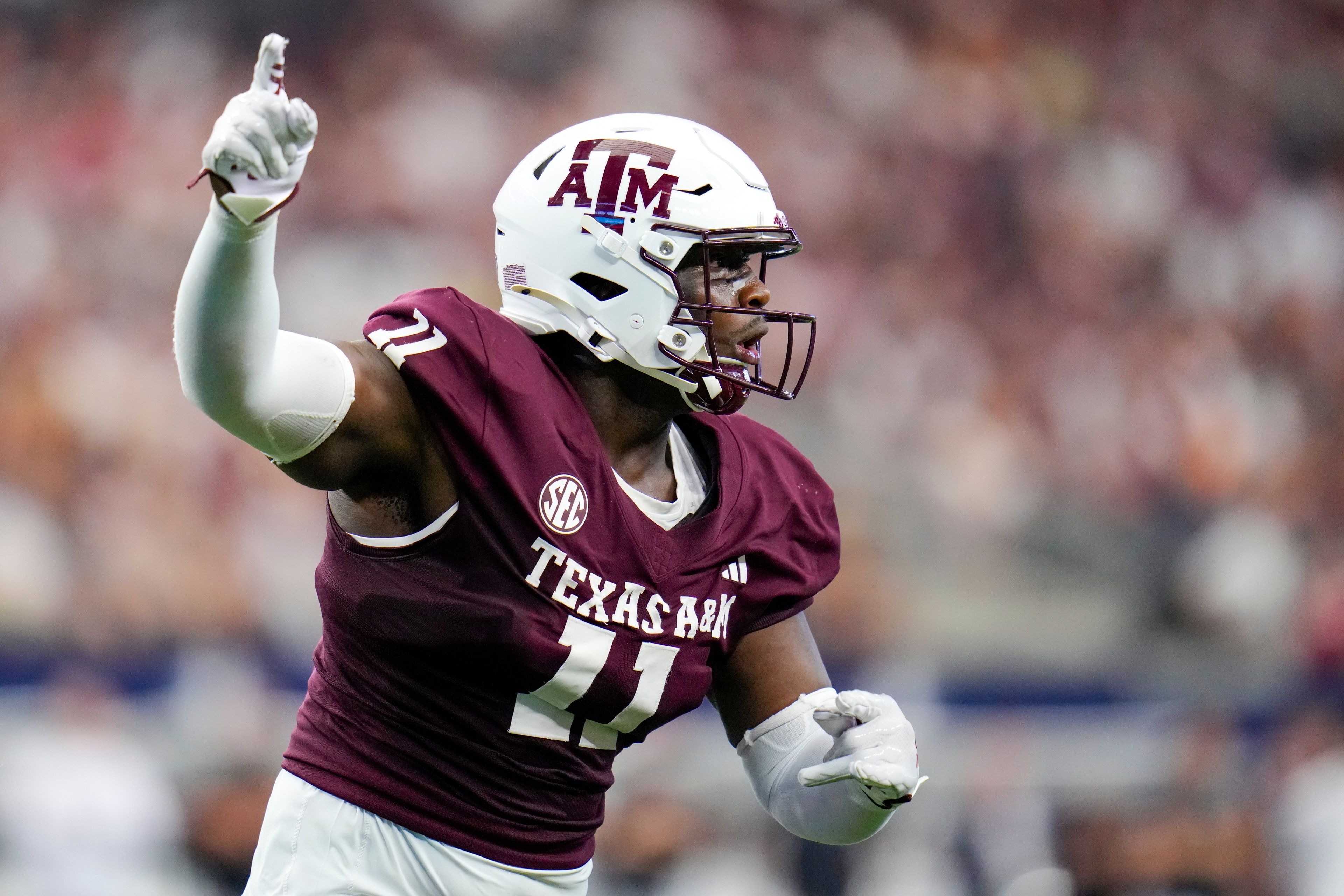 Texas A&M defensive lineman Nic Scourton gestures during the first half of an NCAA college football game against Arkansas, Saturday, Sept. 28, 2024, in Arlington, Texas. (AP Photo/Julio Cortez)