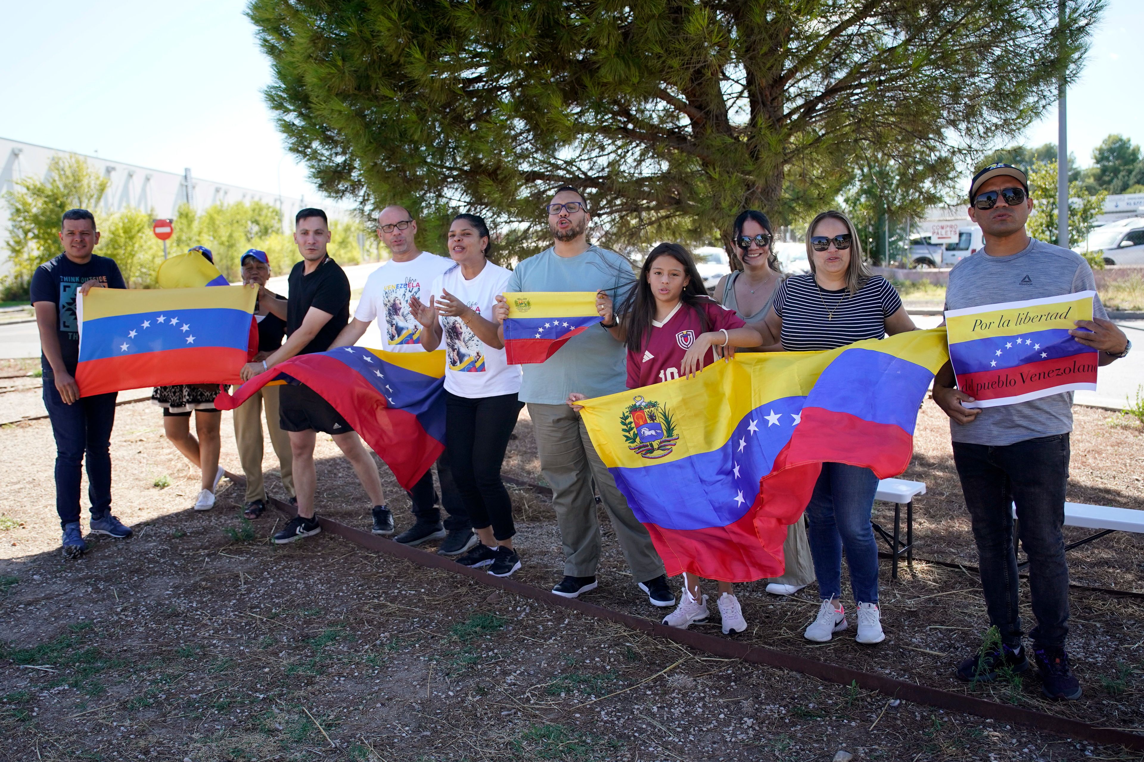 Supporters of Edmundo González wait for his arrival outside the Torrejón Air Base in Madrid, Spain, Sunday, Sept. 8, 2024. Former Venezuelan opposition presidential candidate Edmundo González has fled into exile after being granted asylum in Spain, delivering a major blow to millions who placed their hopes in his upstart campaign to end two decades of single-party rule. (AP Photo/Andrea Comas)