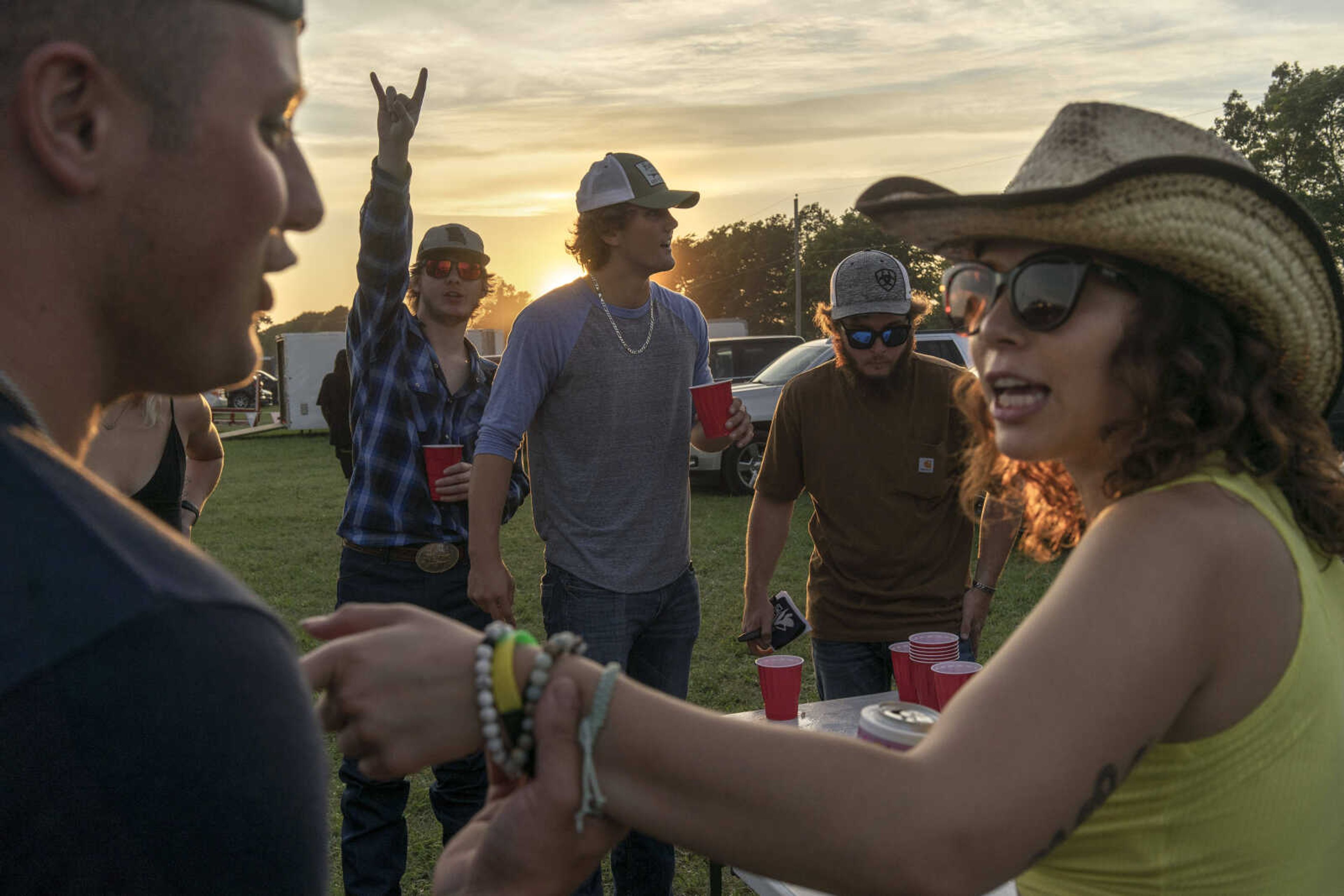 Ayden Tidd, center, and Cameron Speck, center right, enjoy a game of beer pong against Christa Galvin, far right, and Trent Still (not pictured) while tailgating during the last night of the Sikeston Jaycee Bootheel Rodeo Saturday, Aug. 14, 2021,&nbsp;in Sikeston, Missouri.