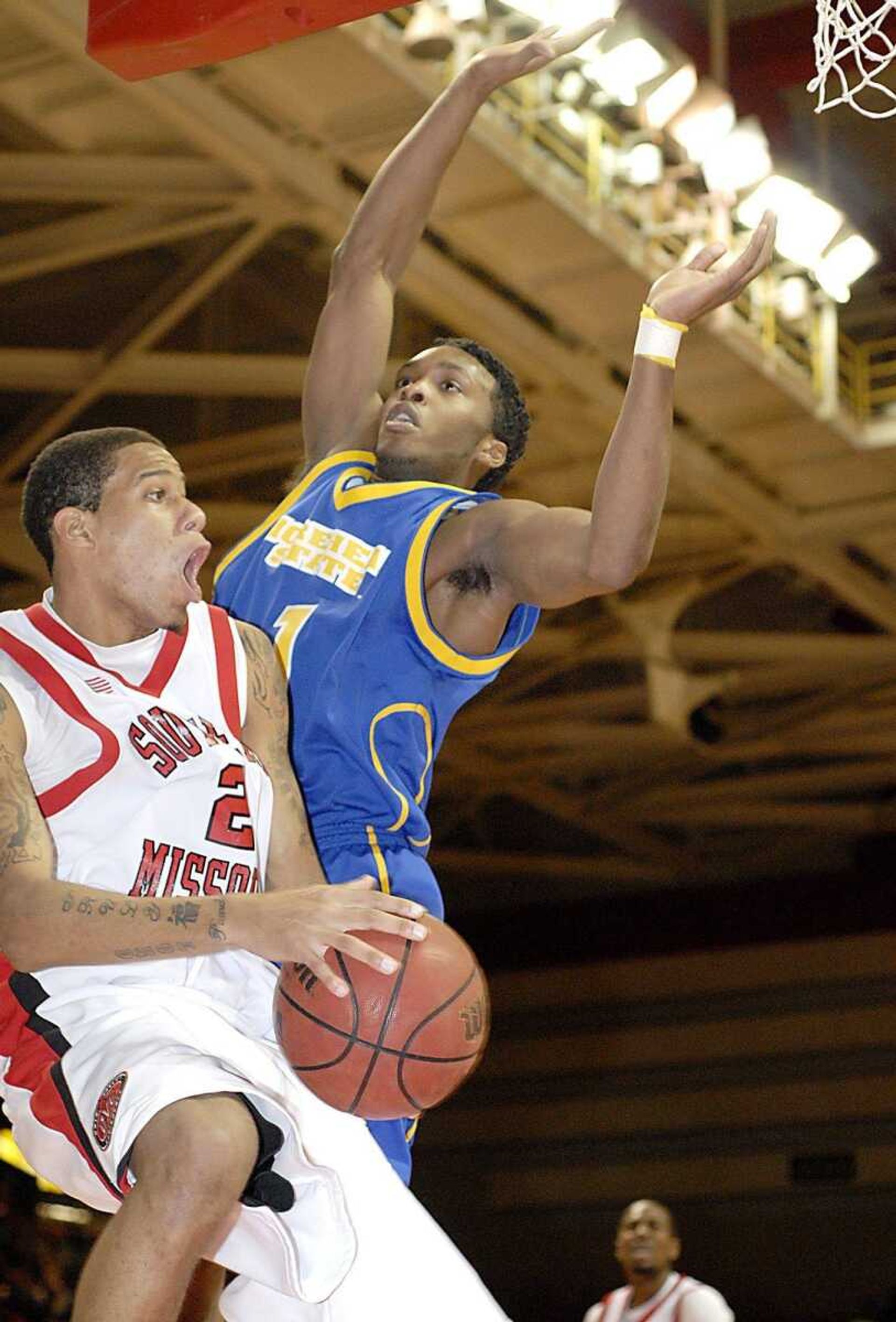 Southeast's Jaycen Herring looked to pass around Morehead State defender Maze Stallworth as he drove under the basket. (Kit Doyle)