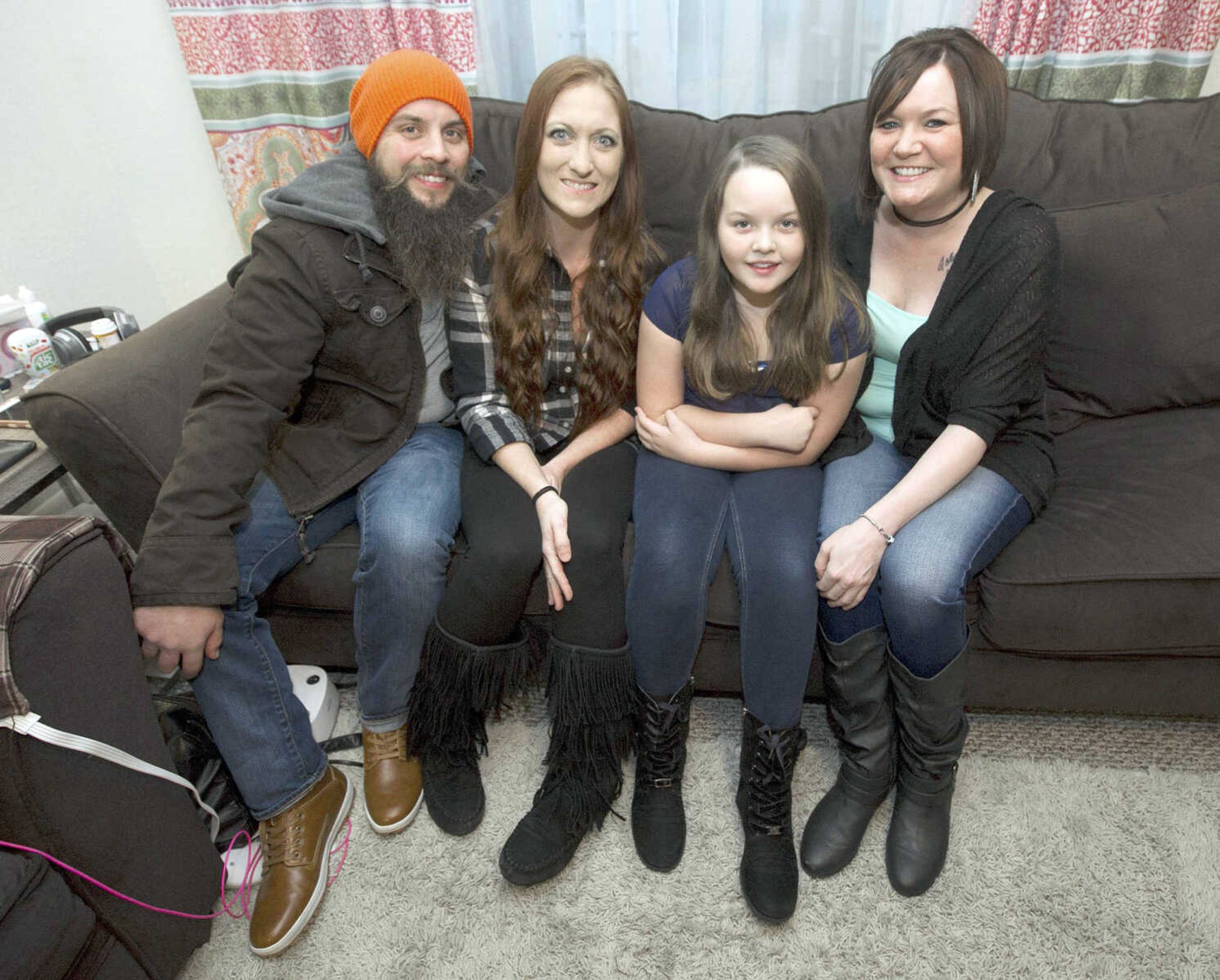 Caryn Durbin, right, poses for photo with her daughter, Bailey Artinger, 10, and Bailey's stepmother, Tiffany Artinger, and father Nate Artinger, on Dec. 22 at Durbin's home during a family Christmas celebration in Joplin, Missouri. Durbin said she is blessed to have Tiffany as a second mom for Bailey, adding the two are best friends.