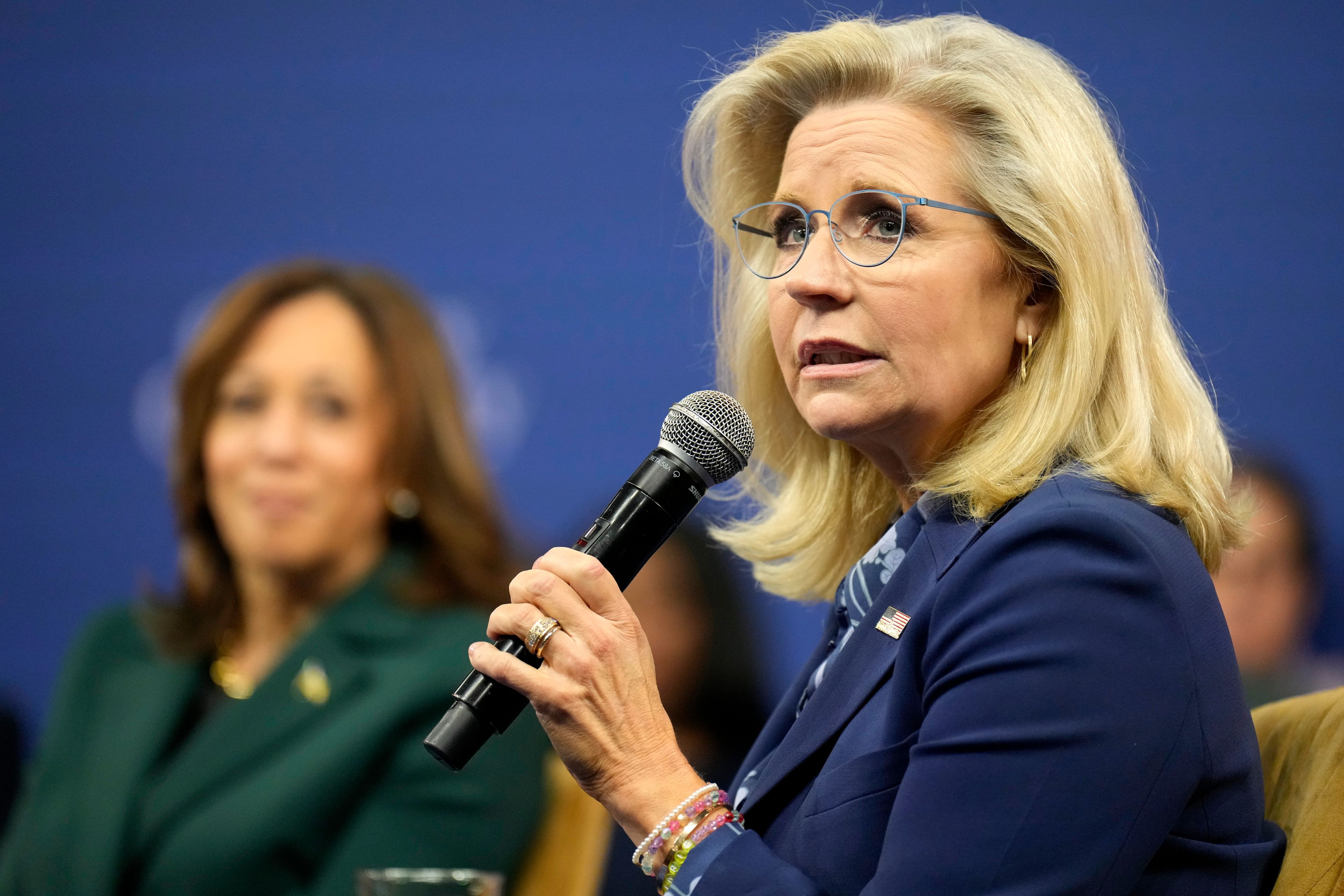 Former Republican Congresswoman Liz Cheney speaks during a town hall with Democratic presidential nominee Vice President Kamala Harris, in background, at The People's Light in Malvern, Pa., Monday, Oct. 21, 2024. (AP Photo/Jacquelyn Martin)