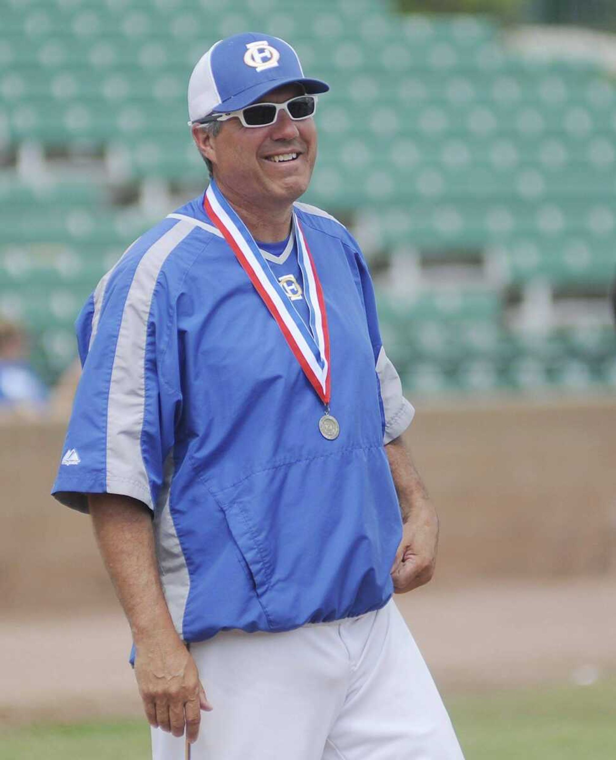 Oran baseball coach Mitch Wood smiles as his players accept the championship trophy after the Eagles' 8-4 win over the Santa Fe Chiefs in the Class 1 championship game Wednesday, May 29, at T.R. Hughes Ballpark in O'Fallon, Mo. It is the first state championship in school history. (Adam Vogler)