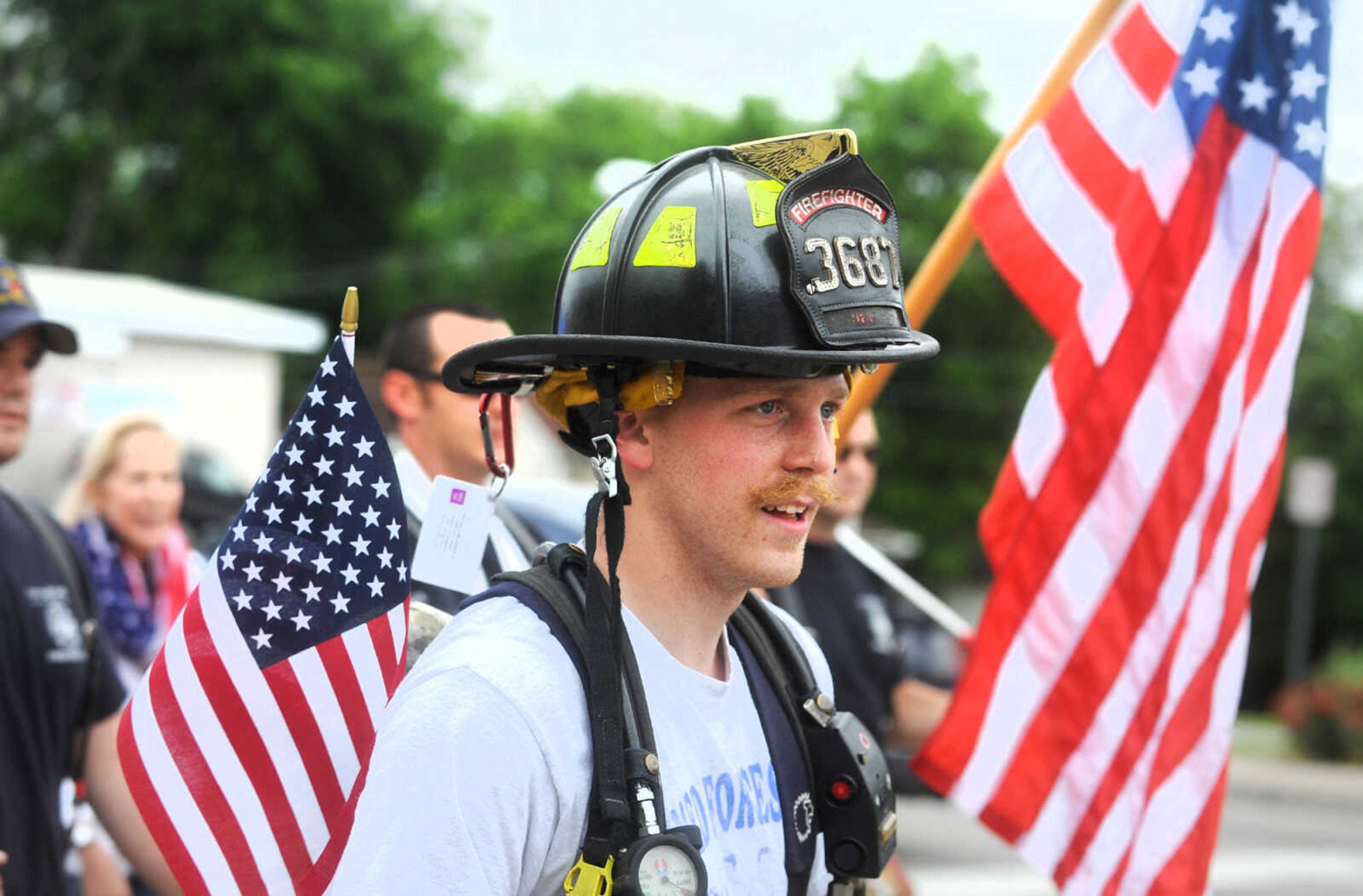 LAURA SIMON ~ lsimon@semissourian.com

Nick August walks with other participants along Broadway in the first ever Carry the Load event, Monday, May 25, 2015, in Cape Girardeau.