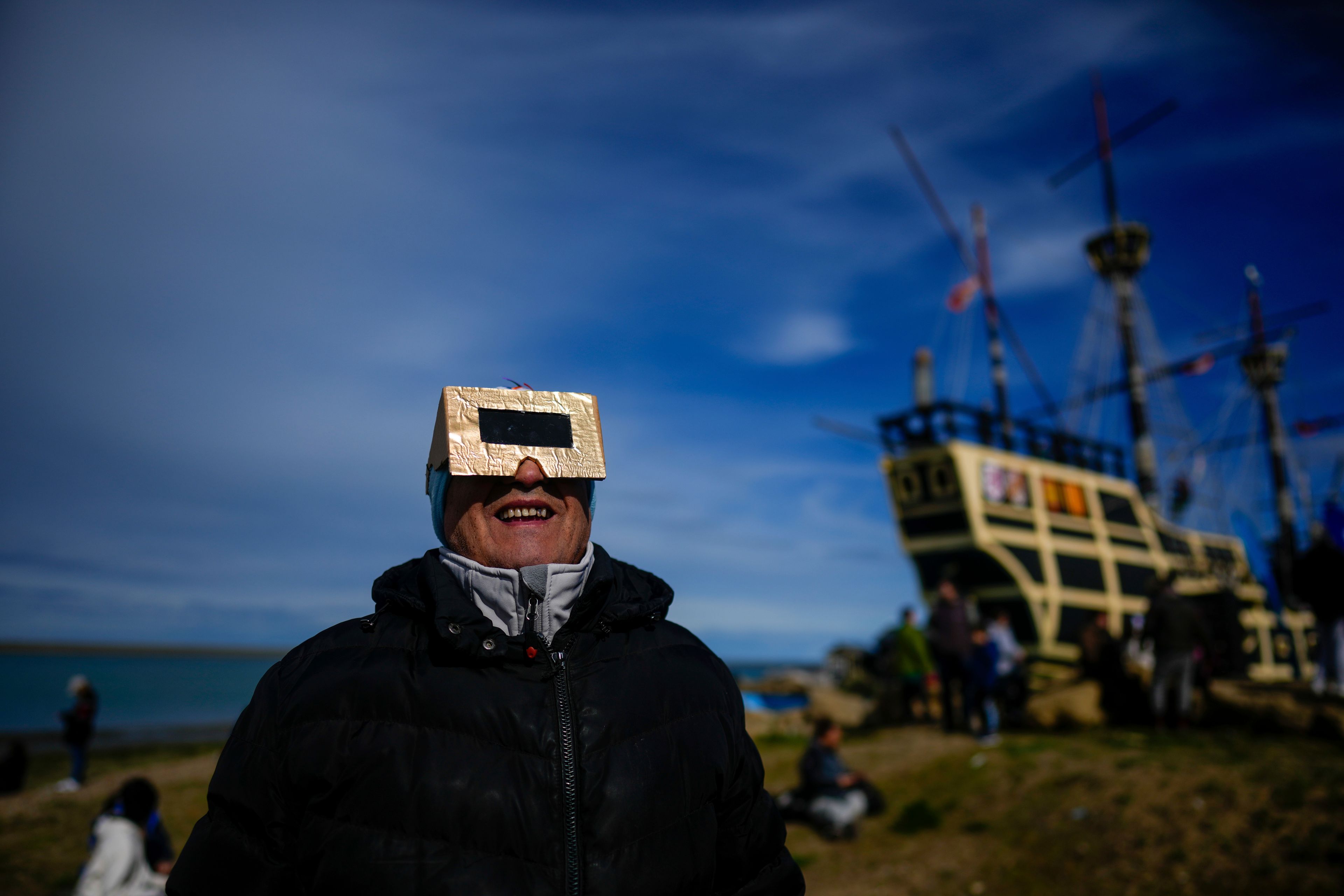 People watch an annular solar eclipse in Puerto San Julian, Argentina, Wednesday, Oct. 2, 2024. (AP Photo/Natacha Pisarenko)