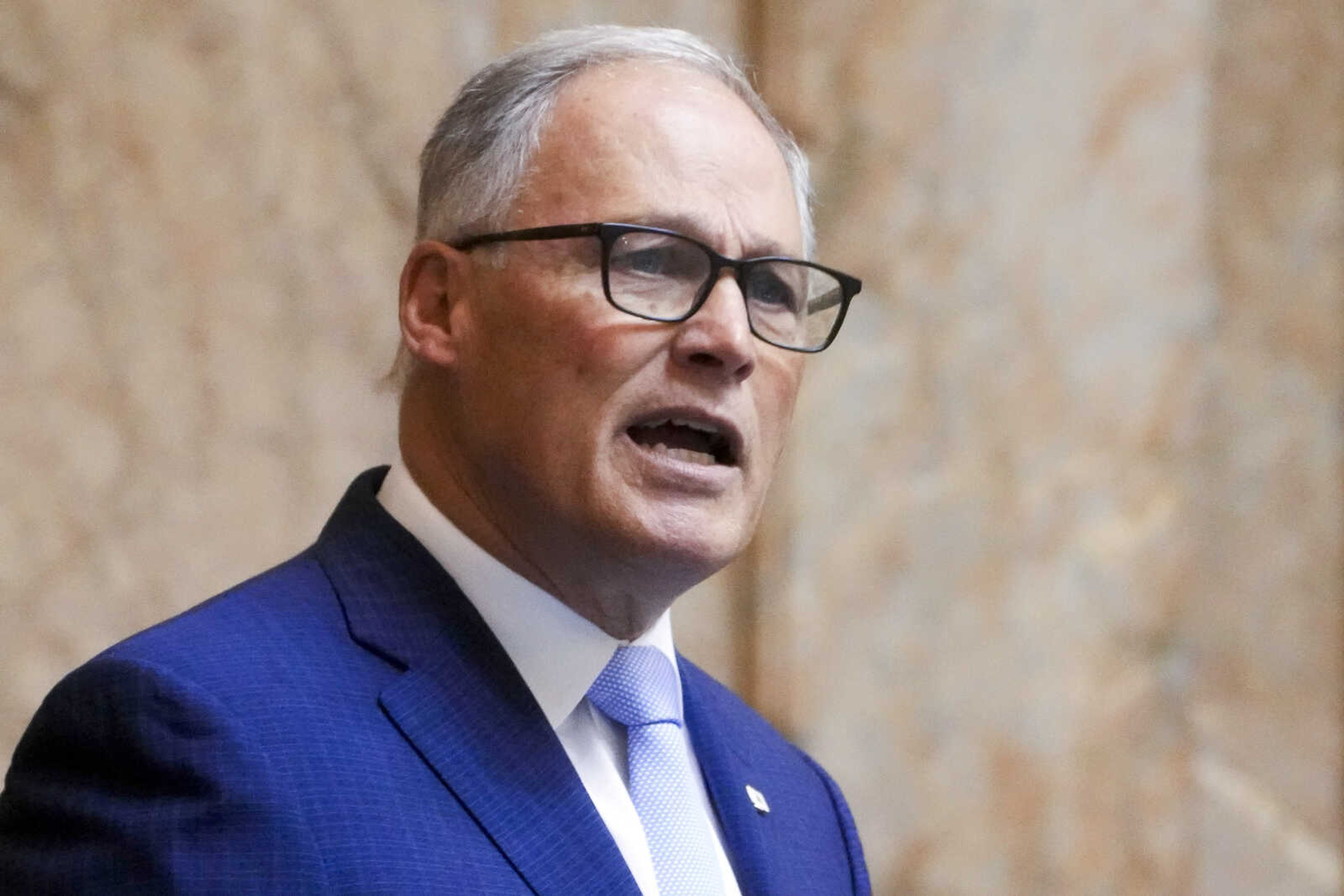 FILE - Washington Gov. Jay Inslee delivers his annual State of the State address to a joint legislative session in House chambers at the Washington state Capitol, Tuesday, Jan. 9, 2024, in Olympia, Wash. As Washington state lawmakers finalize a trio of statewide supplemental budgets featuring new investments in everything from curbing the opioid crisis to electric ferries, they're facing one glaring uncertainty: billions of dollars that could disappear after November. (AP Photo/Lindsey Wasson, File)