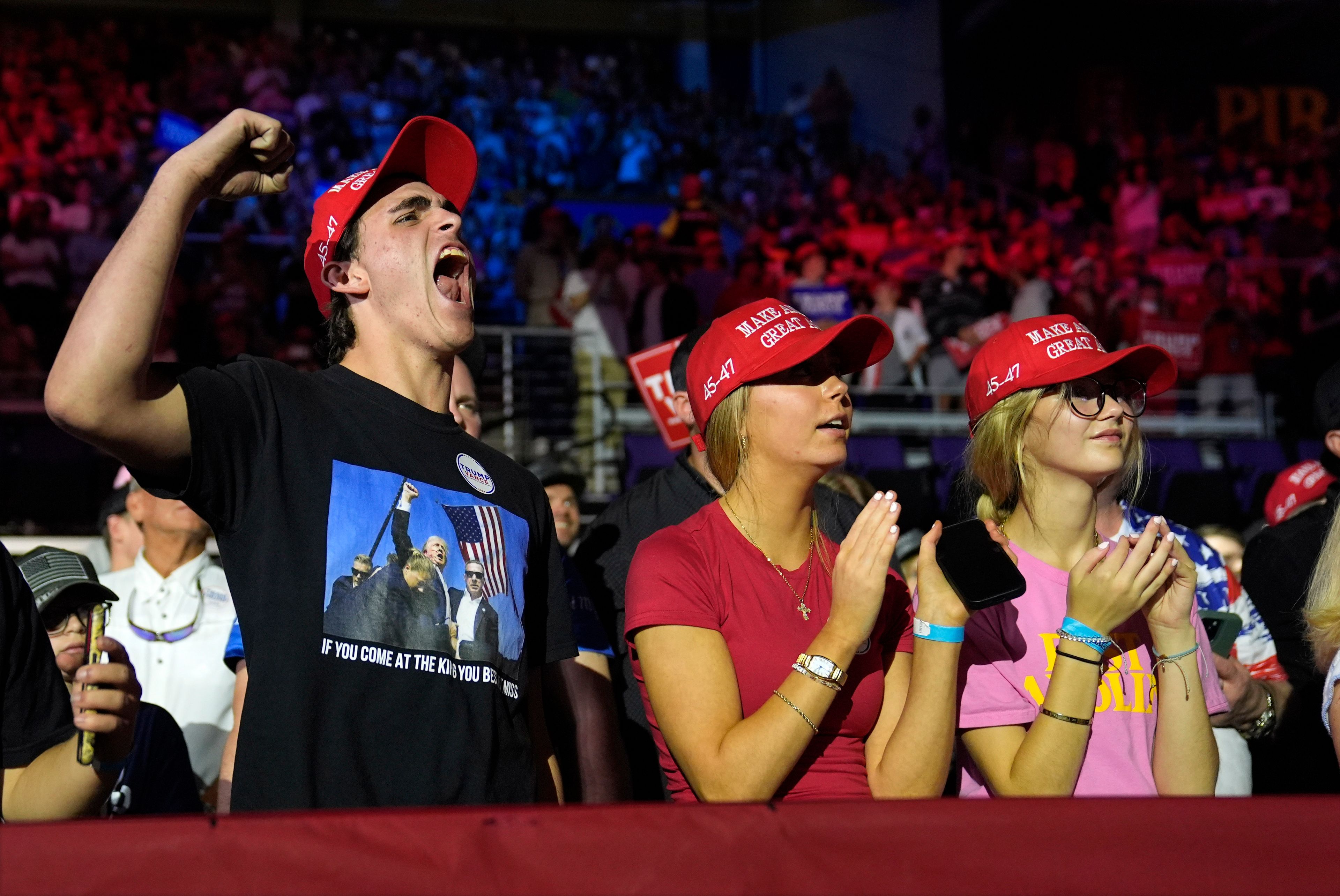 Supporters react as Republican presidential nominee former President Donald Trump arrives for a campaign rally at Williams Arena at Mignes Coliseum, Monday, Oct. 21, 2024, in Greenville, N.C. (AP Photo/Evan Vucci)