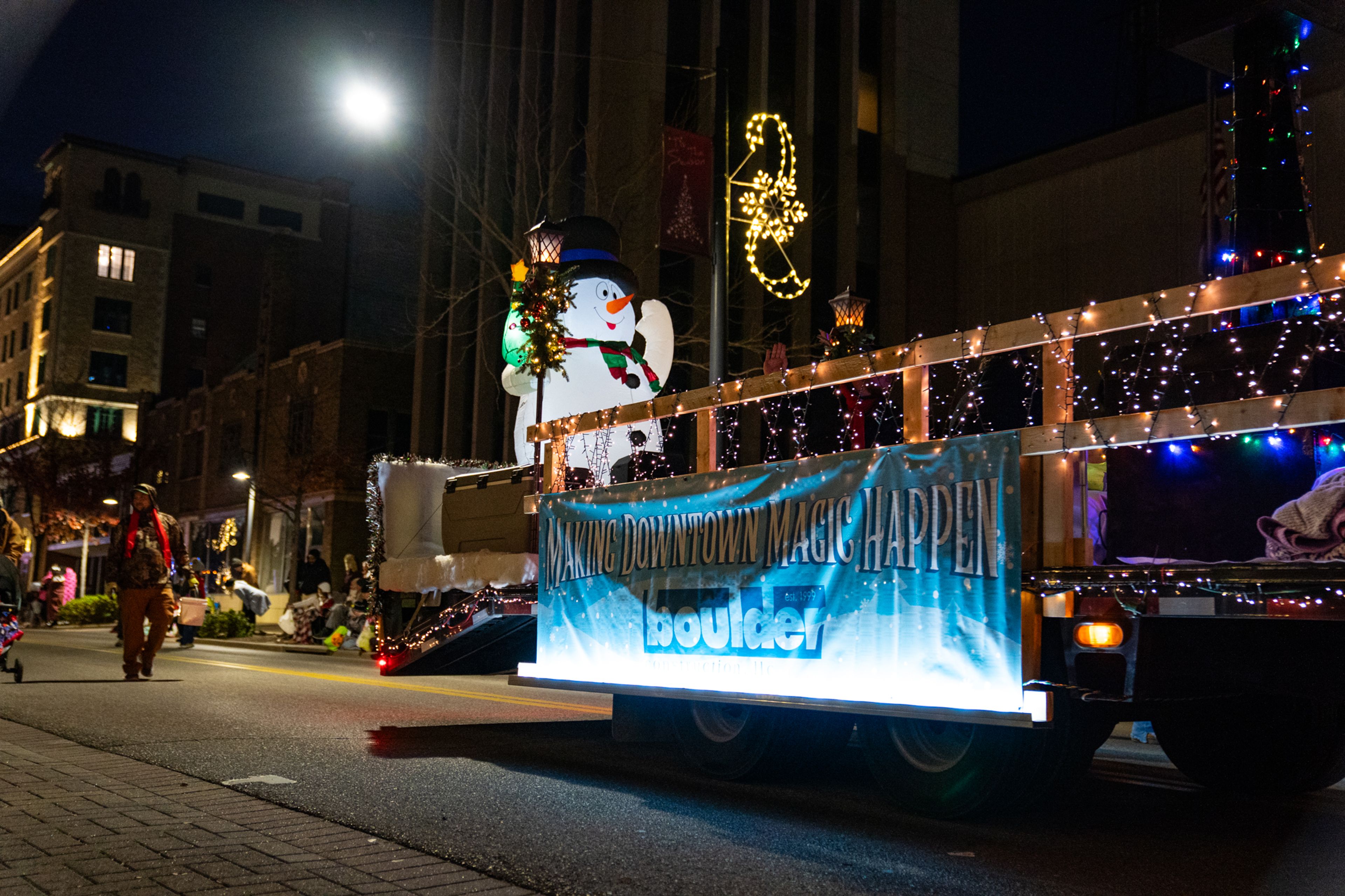 A large blow-up snowman 
makes an appearance on Boulder Construction, LLC's parade float on Sunday, Dec. 1.