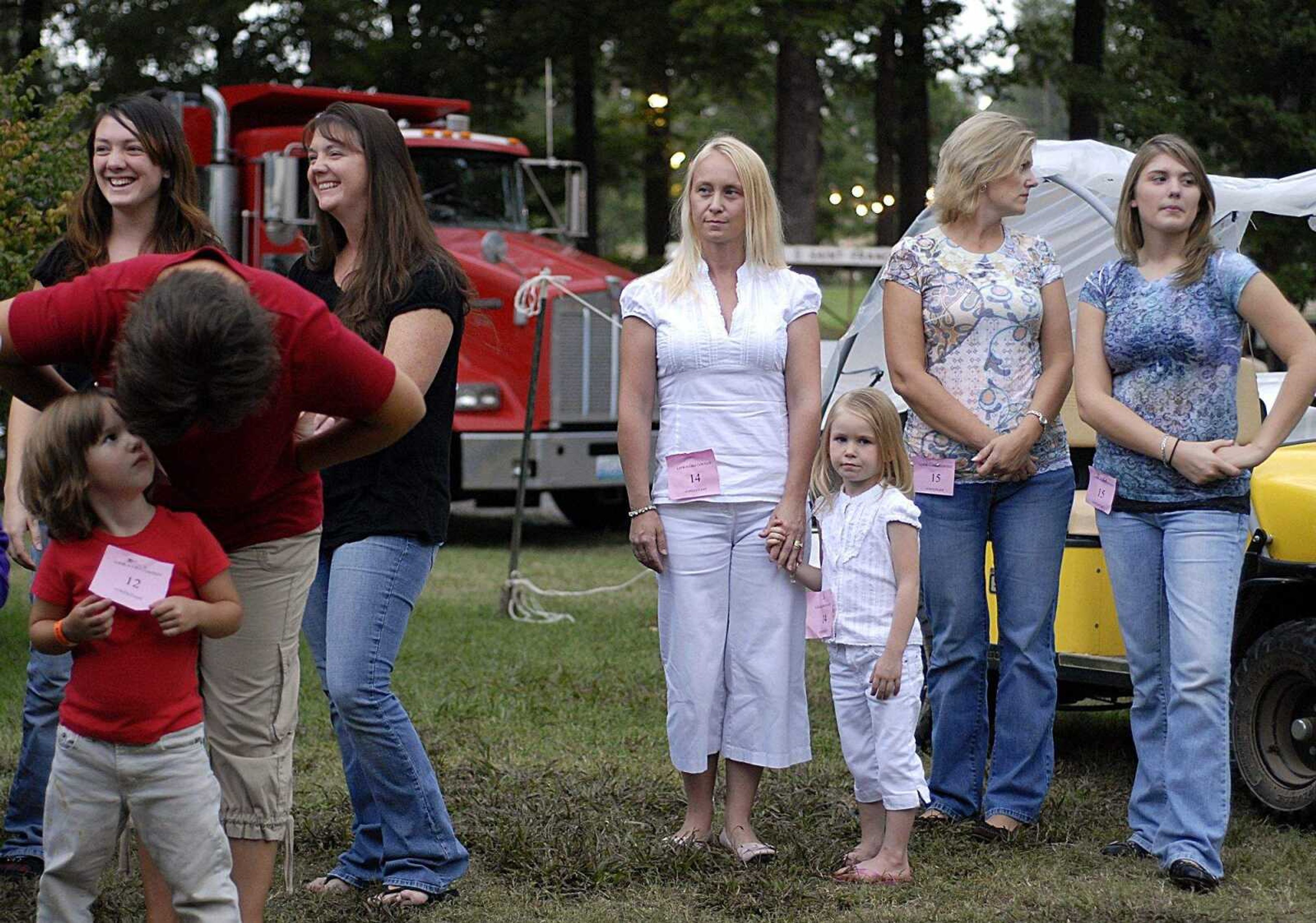 AARON EISENHAUER ~ aeisenhauer@semissourian.com
Misty and Isabelle Arthur, 4, stand dressed in white amongst the other contestants as they wait their turn to appear on stage in the Mother/Daughter Look-A-Like Contest.