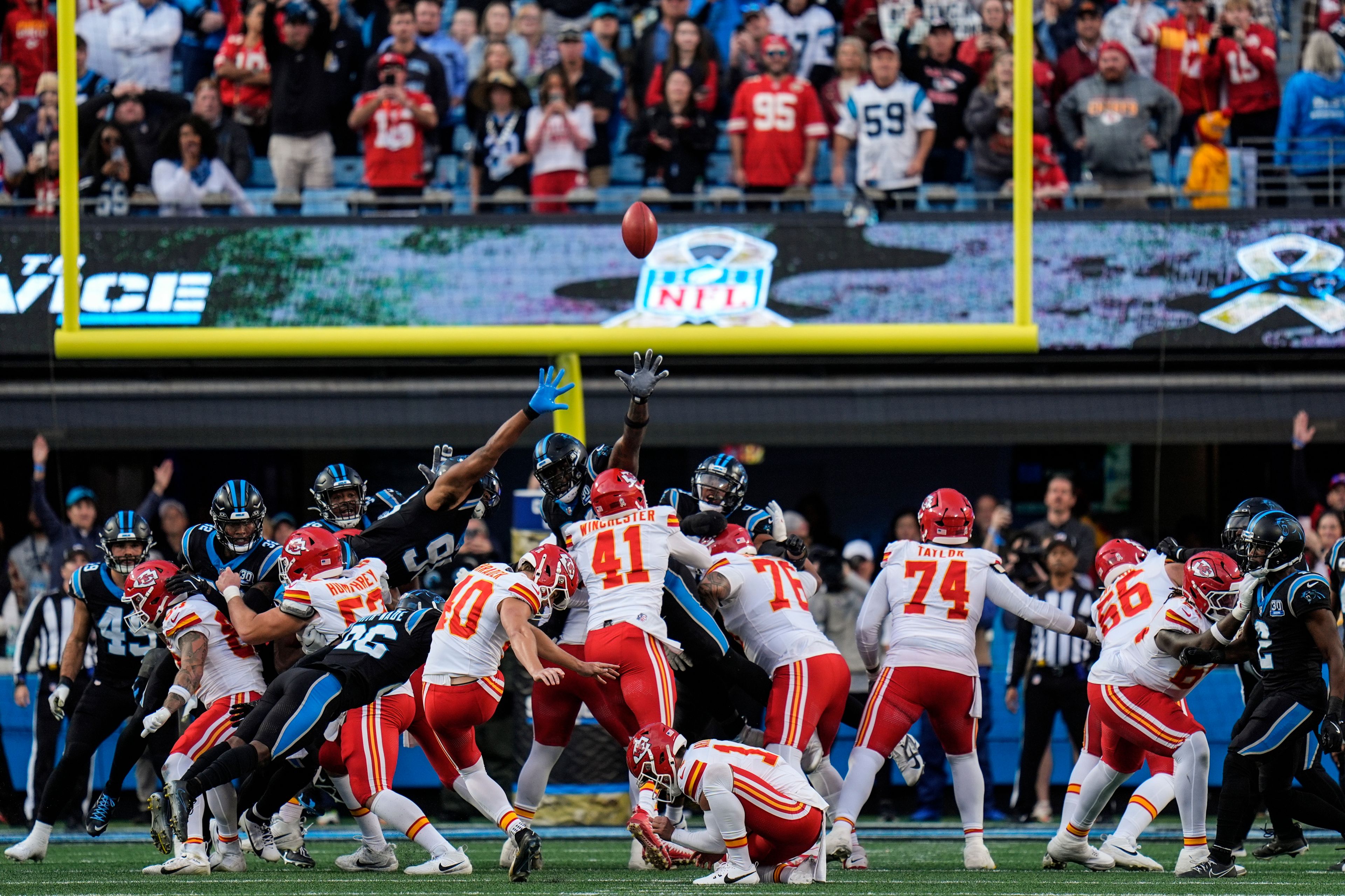 Kansas City Chiefs place kicker Spencer Shrader (40) kicks the game-winning field goal in overtime during an NFL football game against the Carolina Panthers, Sunday, Nov. 24, 2024, in Charlotte, N.C. (AP Photo/Rusty Jones)