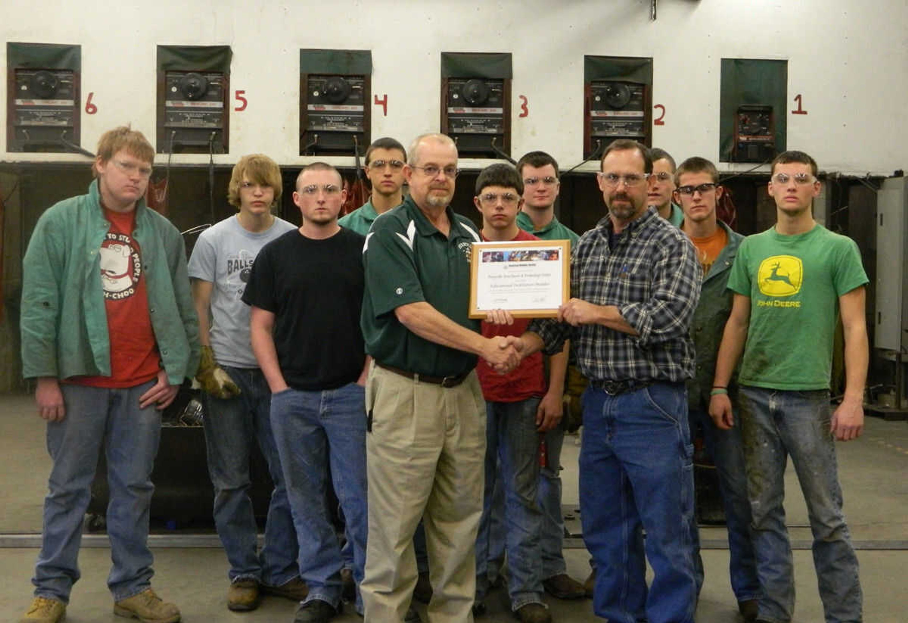 Pictured above are: (from left) Dustin Berry, Von Hagan, Mike Choate, Trent Webb, Career Center Director Steve King, Trevor Gross, Dalton Brewer, Welding Instructor Bill Johns, Chase Williams, Luke Janet and Cale Regelsperger.