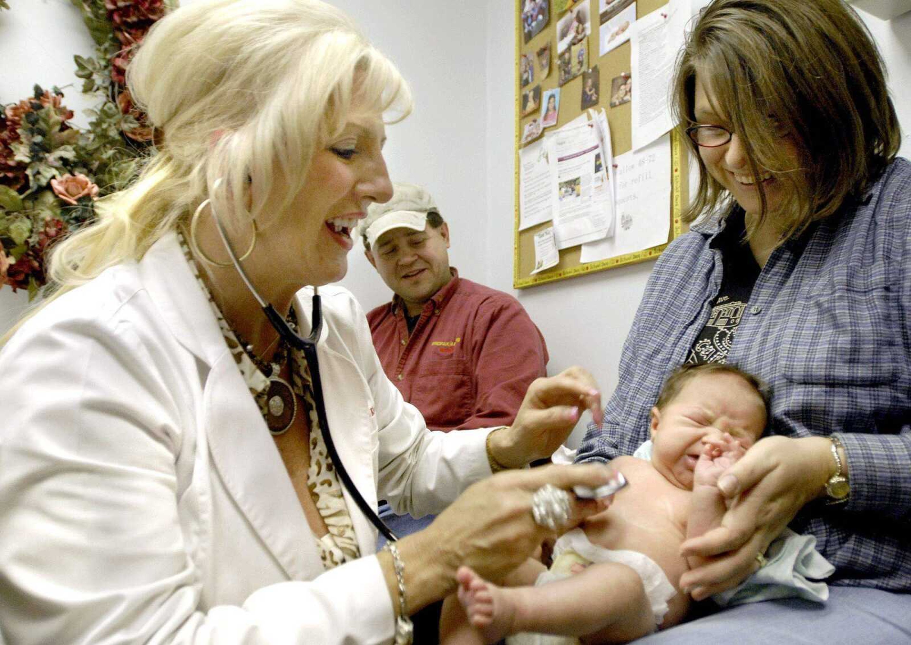 Scott and Paula Niedbalski take 6-week-old Rebecca Niedbalski to nurse practitioner Kimberly Keser for a two-week follow-up visit Tuesday afternoon at AWL Family Healthcare in Cape Girardeau. (Laura Simon)