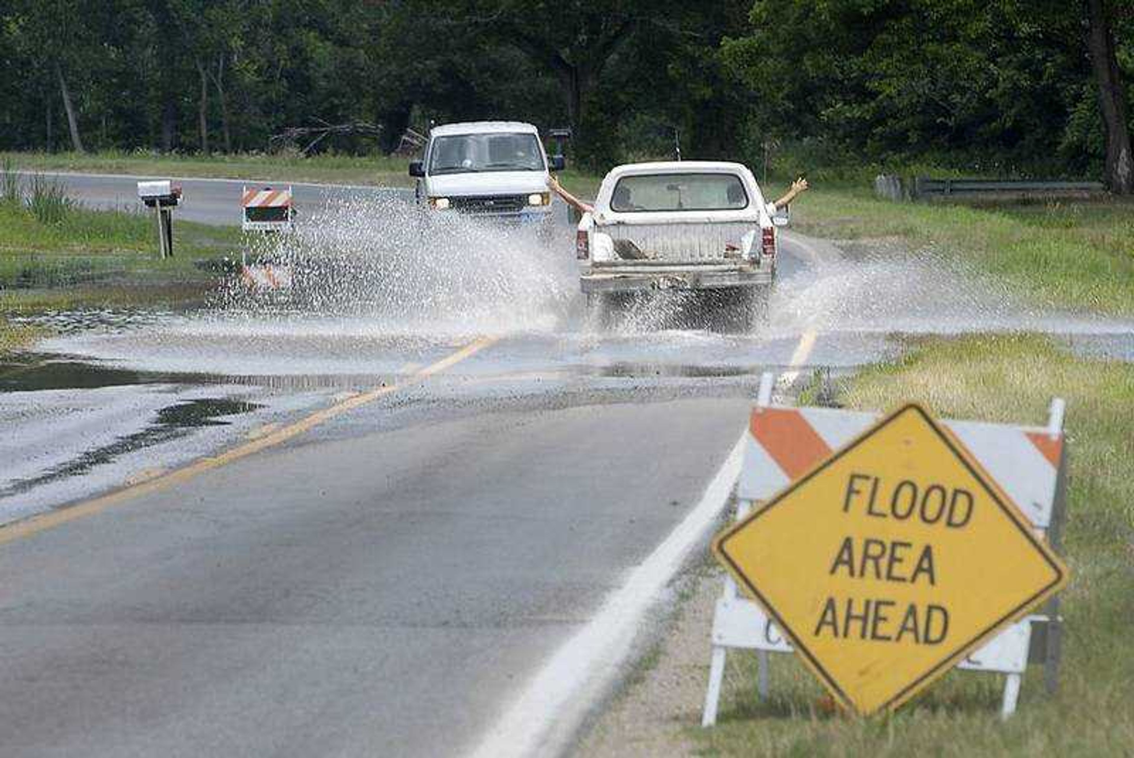 KIT DOYLE ~ kdoyle@semissourian.com
Traffic stopped along Highway 177 just north of Cape Girardeau to let one lane at a time through floodwaters that backed up over the road Thursday, June 26, 2008.