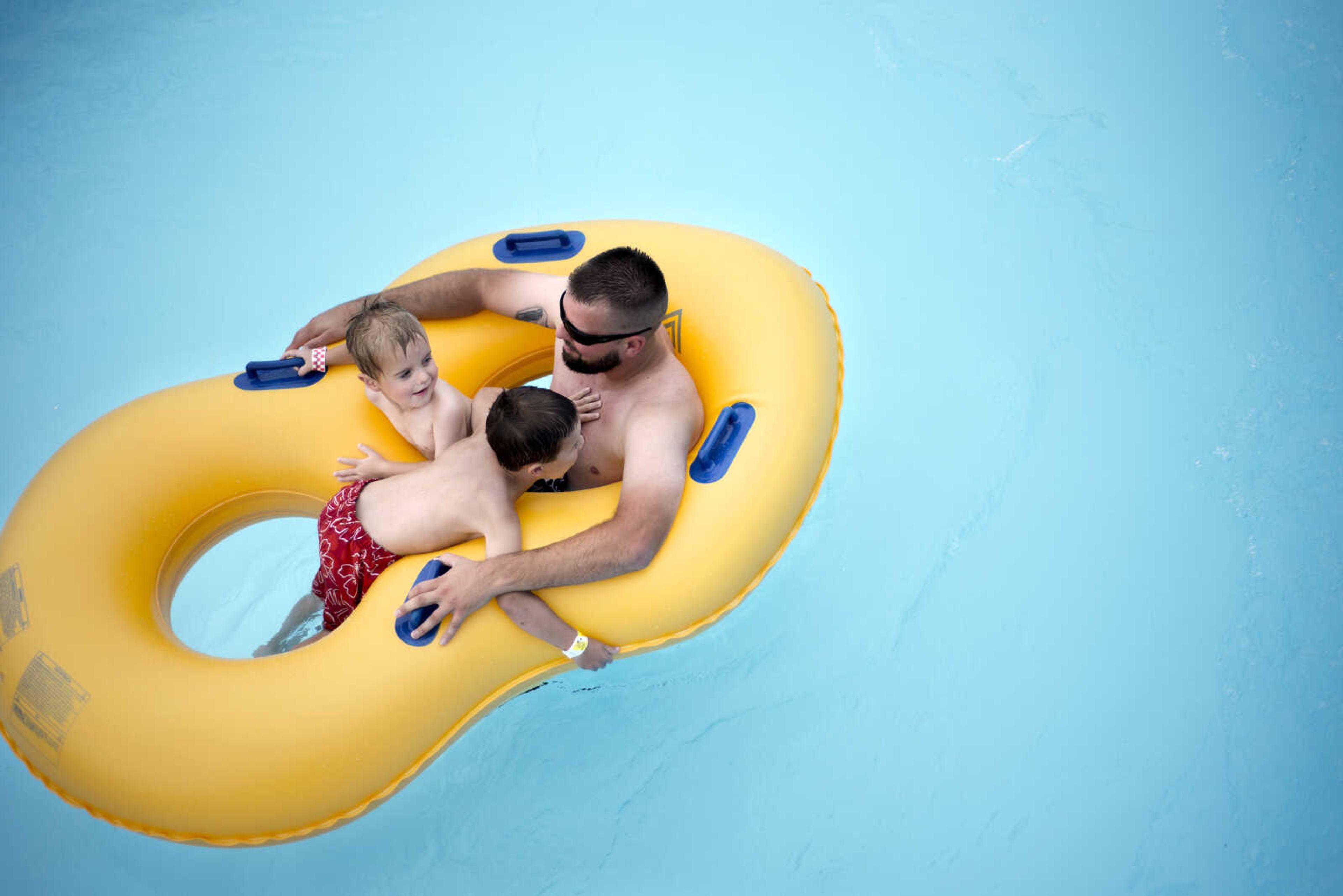 Britt Arnold steers his sons, Kannon and Skylon, towards a waterfall while floating in the Lazy River at Cape Splash on Sunday, Aug. 11, 2019, in Cape Girardeau.