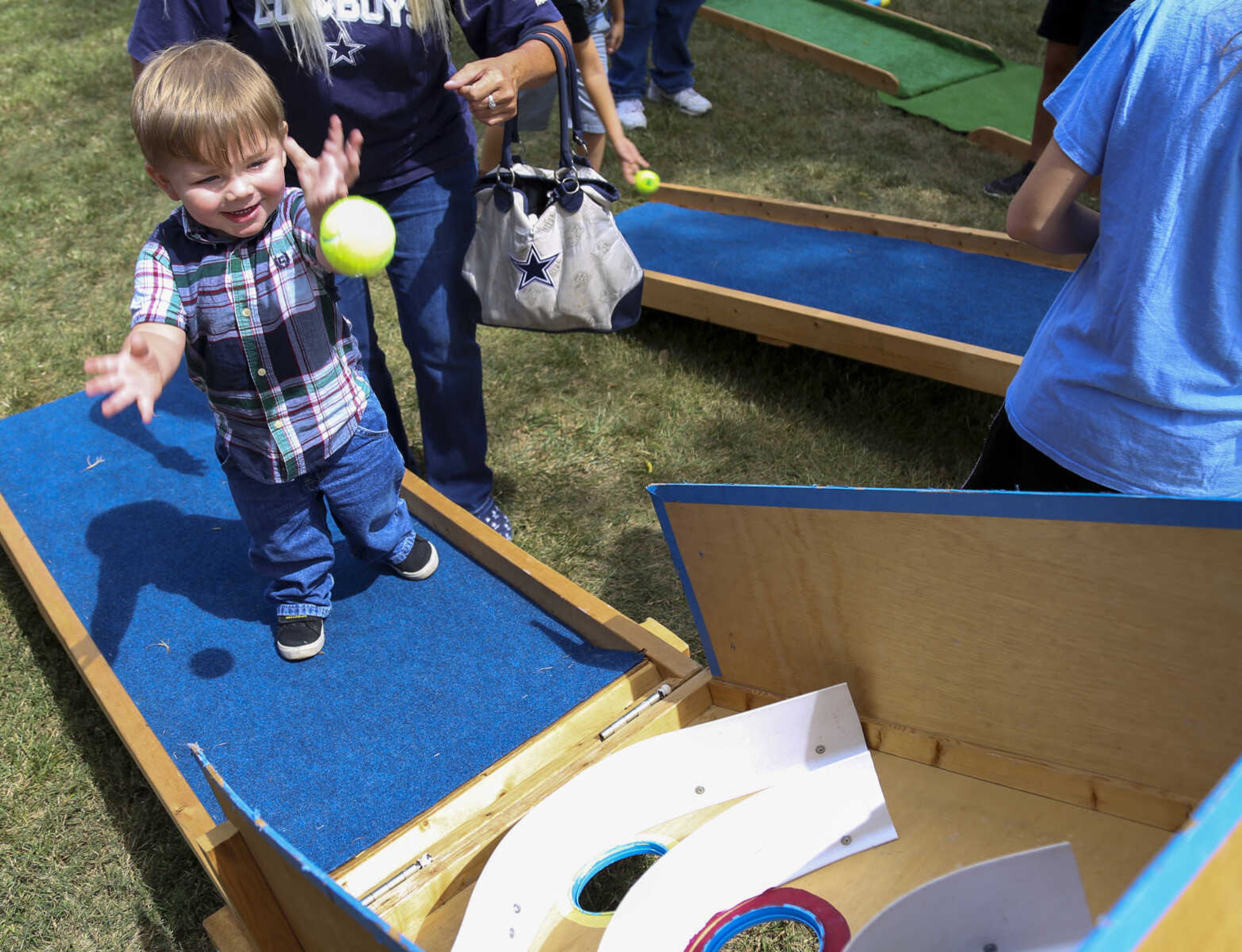 Chance Riggan throws a ball while playing a skee-ball game at the St. Mary Cathedral parish picnic on Sunday, August 27, 2017, in Cape Girardeau.