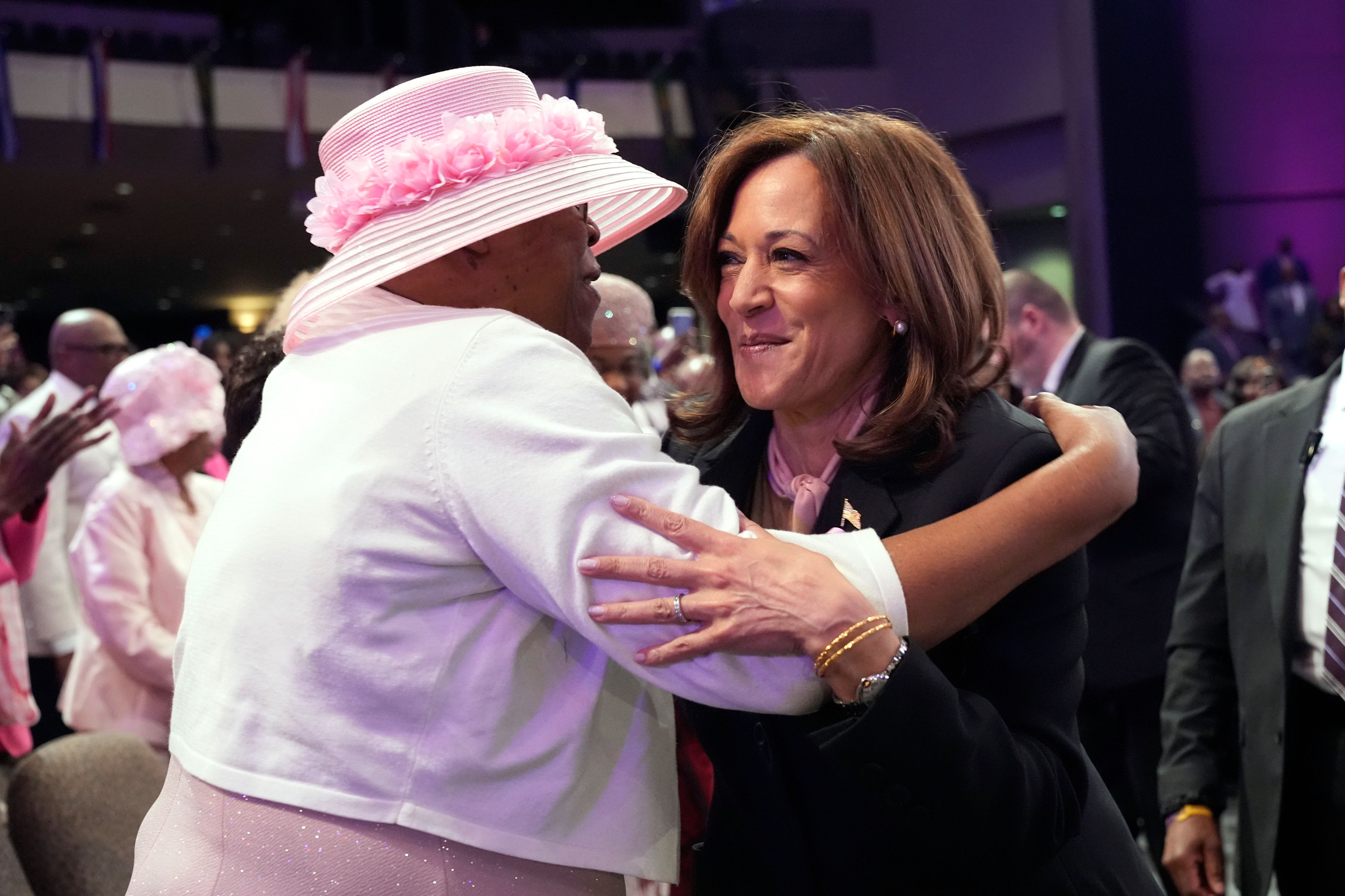 Democratic presidential nominee Vice President Kamala Harris, right, hugs an attendee at a church service before speaking at New Birth Baptist Church in Stonecrest, Ga., Sunday, Oct. 20, 2024. (AP Photo/Jacquelyn Martin)