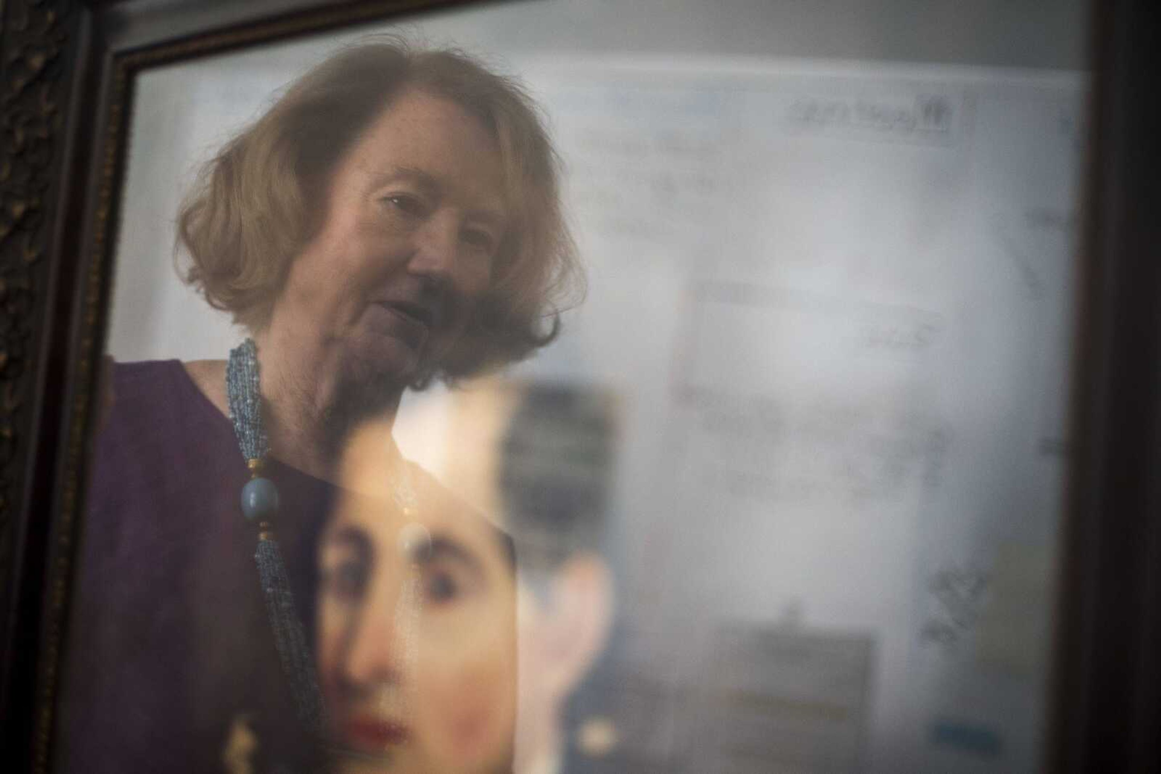 TYLER GRAEF ~ tgraef@semissourian.com    Charlotte Slinkard, who is responsible for making the costumes for figures at the Cape Girardeau River Heritage Museum, is reflected in a painting Friday, May 24, 2019, at the museum in Cape Girardeau.