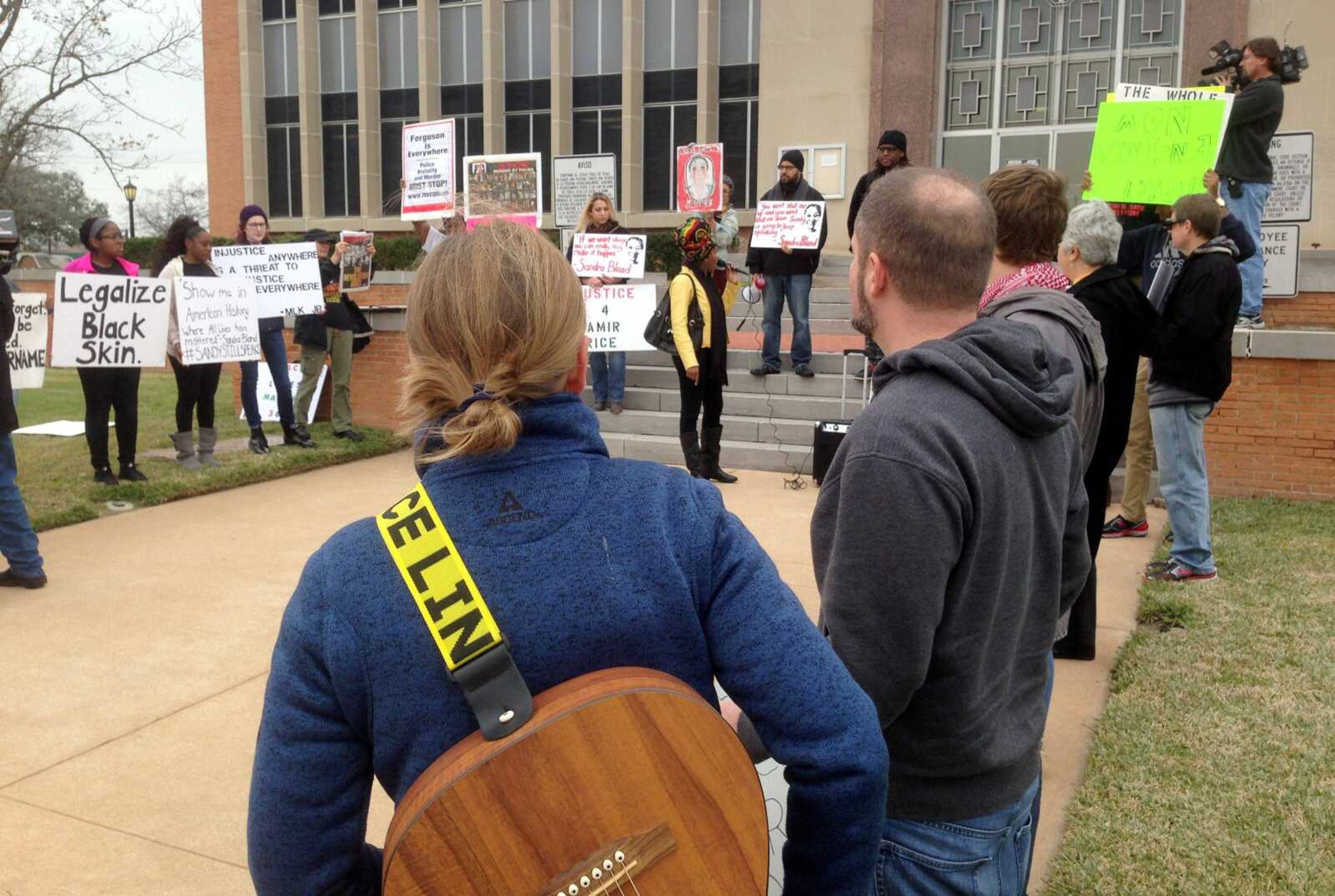 About two dozen people demonstrate Wednesday outside the Waller County Courthouse in Hempstead, Texas. (Michael Graczyk ~ Associated Press)