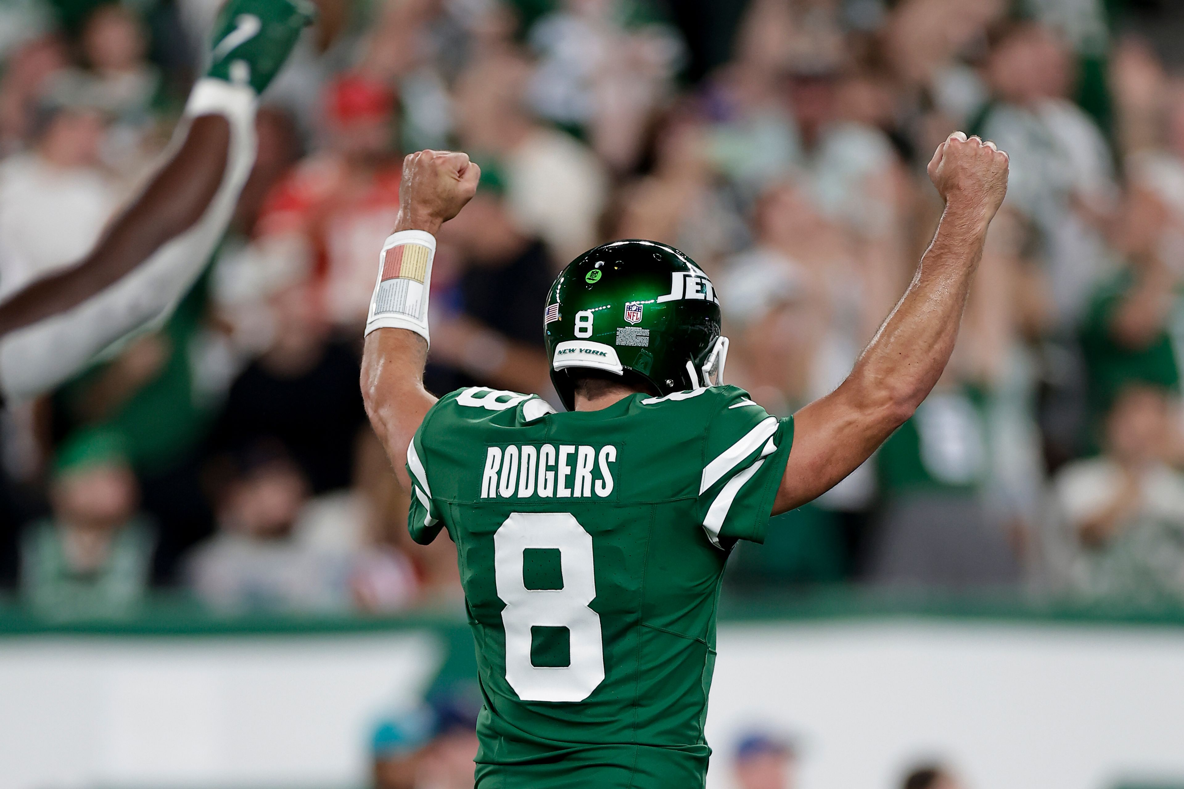 New York Jets quarterback Aaron Rodgers (8) reacts after throwing a touchdown pass against the New England Patriots during the first quarter of an NFL football game, Thursday, Sept. 19, 2024, in East Rutherford, N.J. (AP Photo/Adam Hunger)