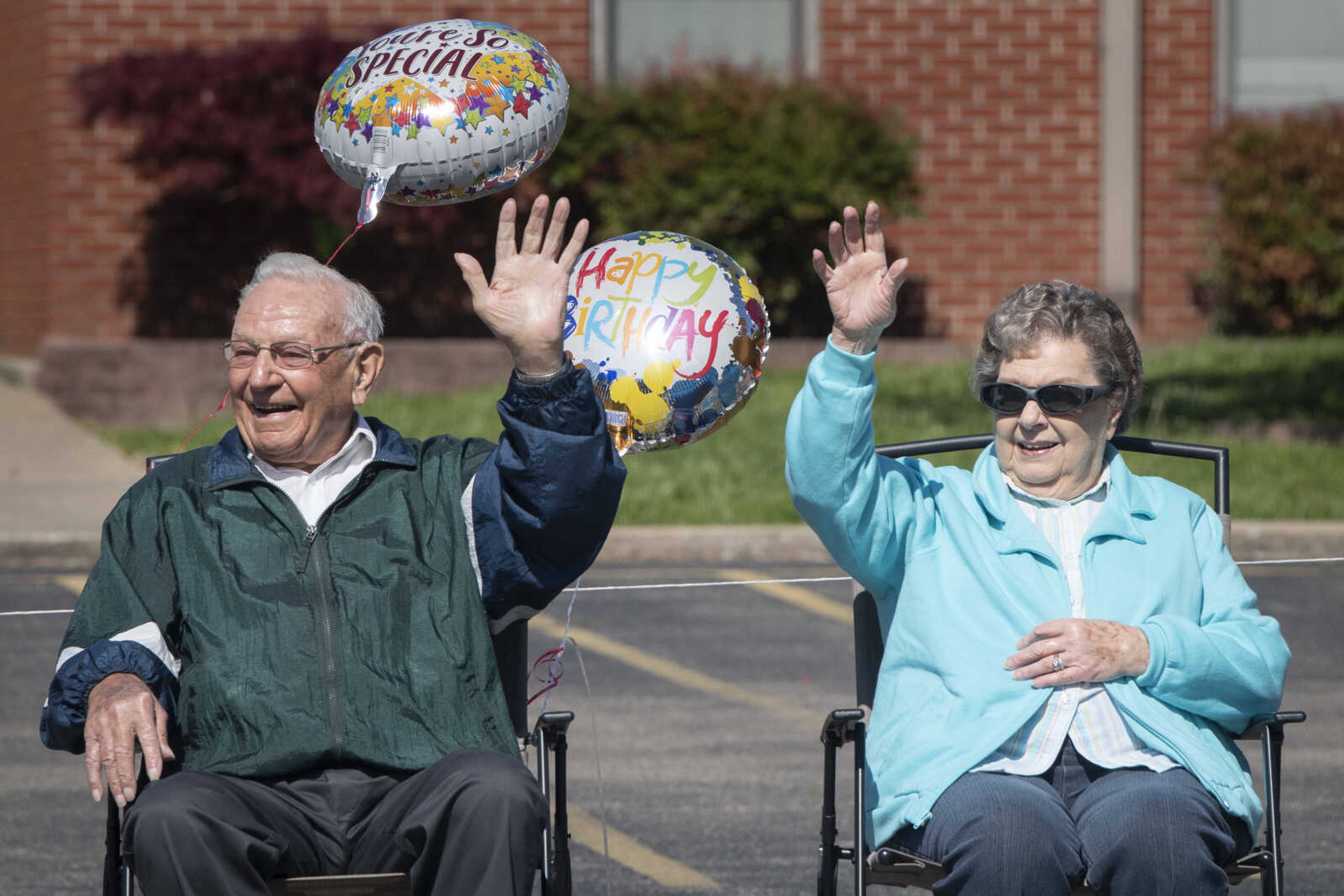 On his 90th birthday, Paul L. Essner of Benton, Missouri, and his wife Bert Essner wave to people passing in a parade celebrating Paul's birthday Saturday, April 18, 2020, outside St. Denis Catholic School in Benton, Missouri.