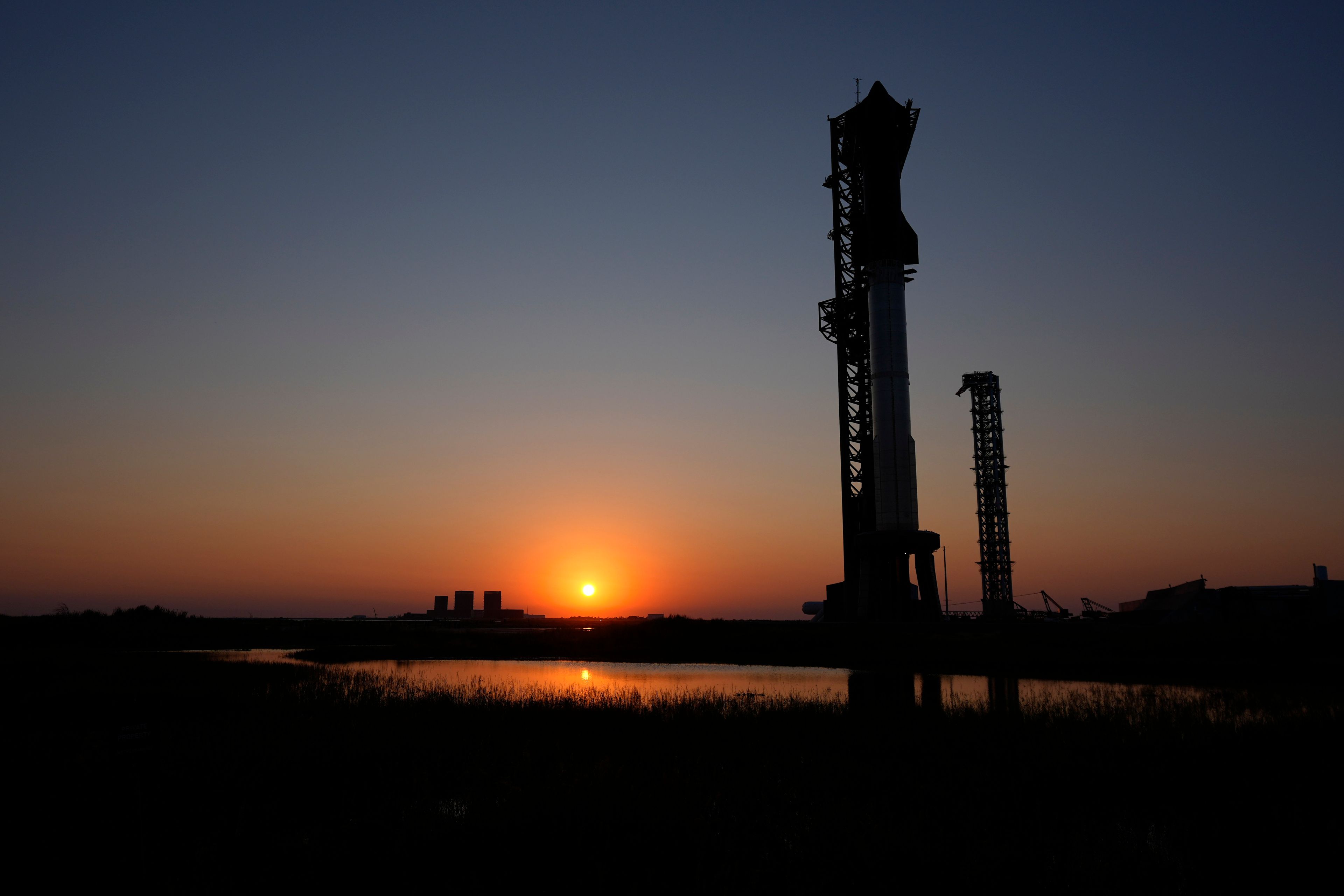 The sun sets behind SpaceX's mega rocket Starship, Saturday, Oct. 12, 2024, in Boca Chica, Texas. (AP Photo/Eric Gay)