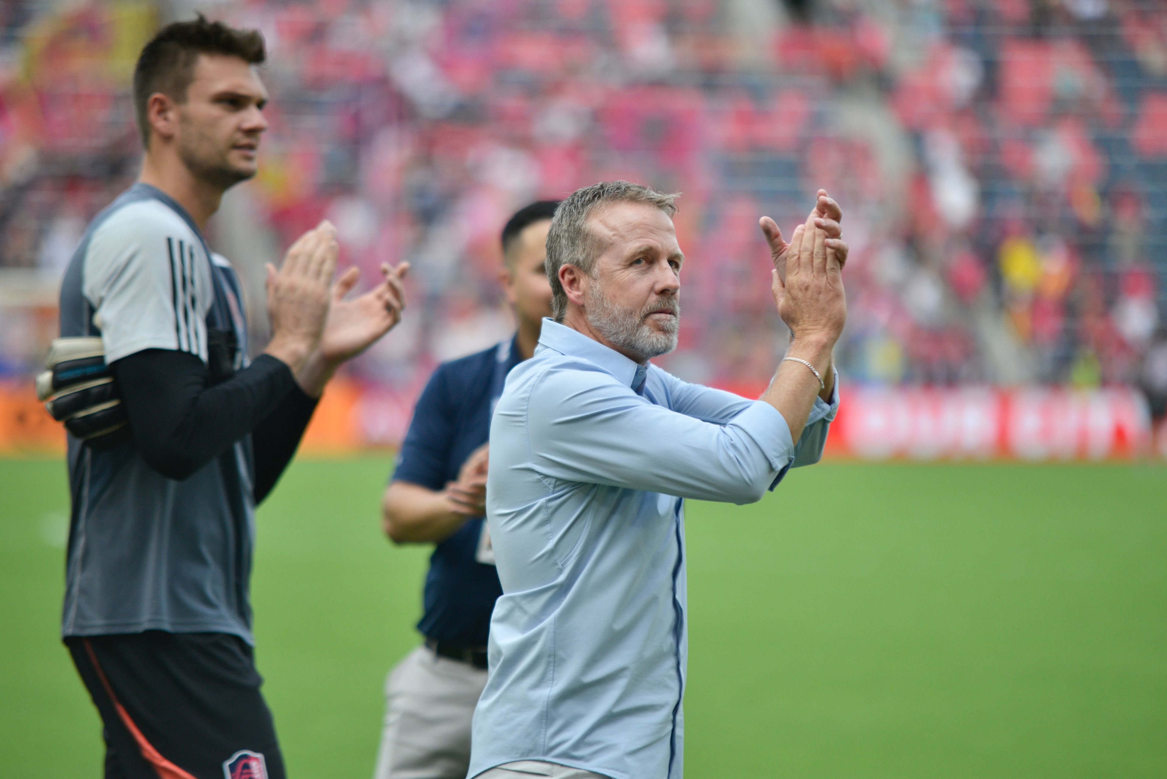 St. Louis City interim head coach John Hackworth applauds the fans after winning a match against the LA Galaxy on Sunday, Sept. 1, in St. Louis. 