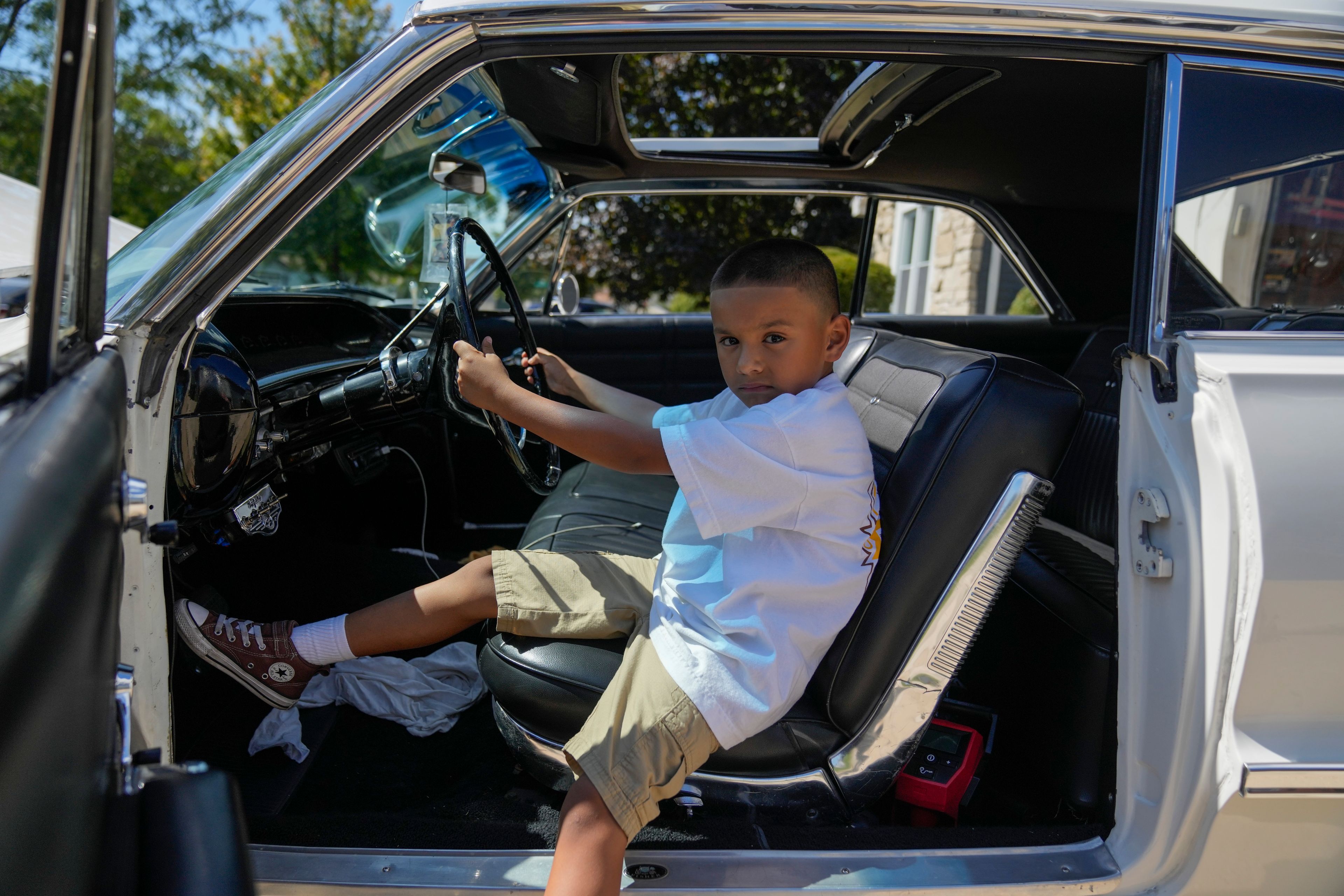 Daniel Marquez, 7, sits inside his late father Alberto's 1963 Chevy Impala lowrider car Saturday, Sept. 14, 2024, in Frankfort, Ill. (AP Photo/Erin Hooley)