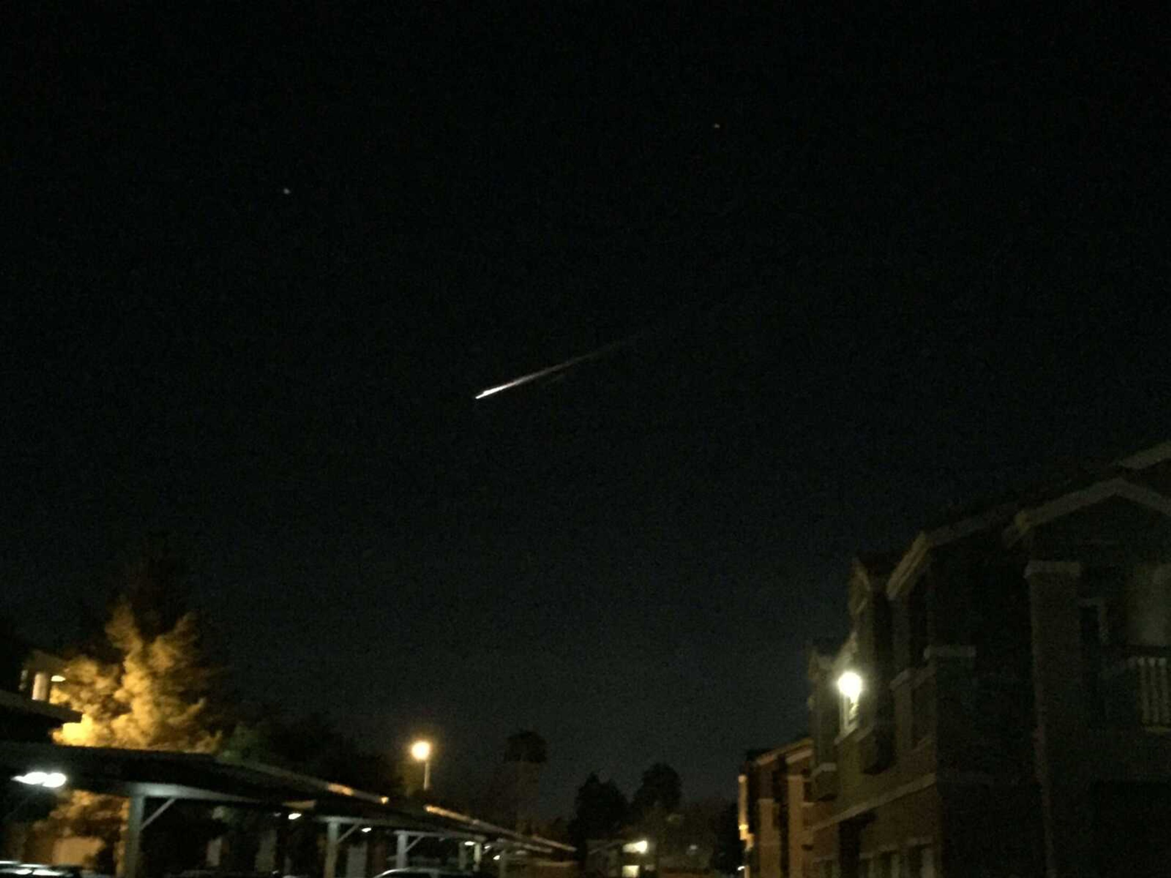 A streak of light is seen Tuesday over an apartment complex in Las Vegas. (Gunnar Lindstrom via AP)