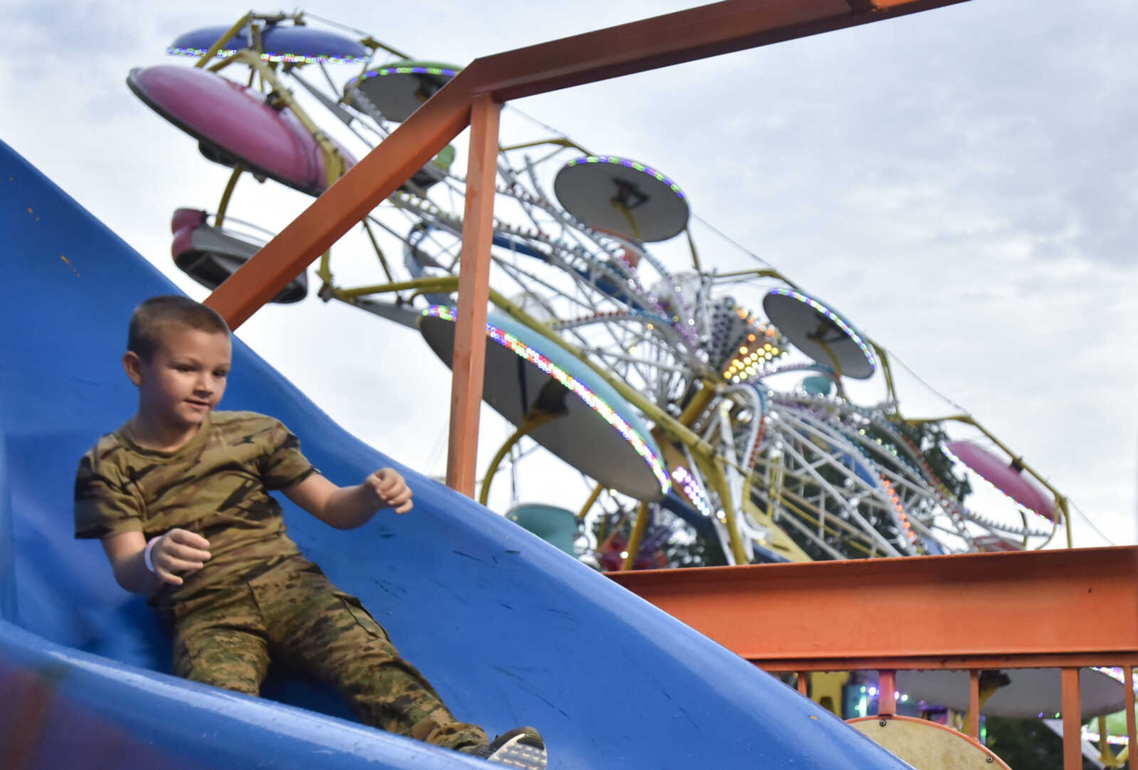 Ethan Butler, 8, rides down a spiral slide on Thursday, July 27, 2018 at Jackson Homecomers.