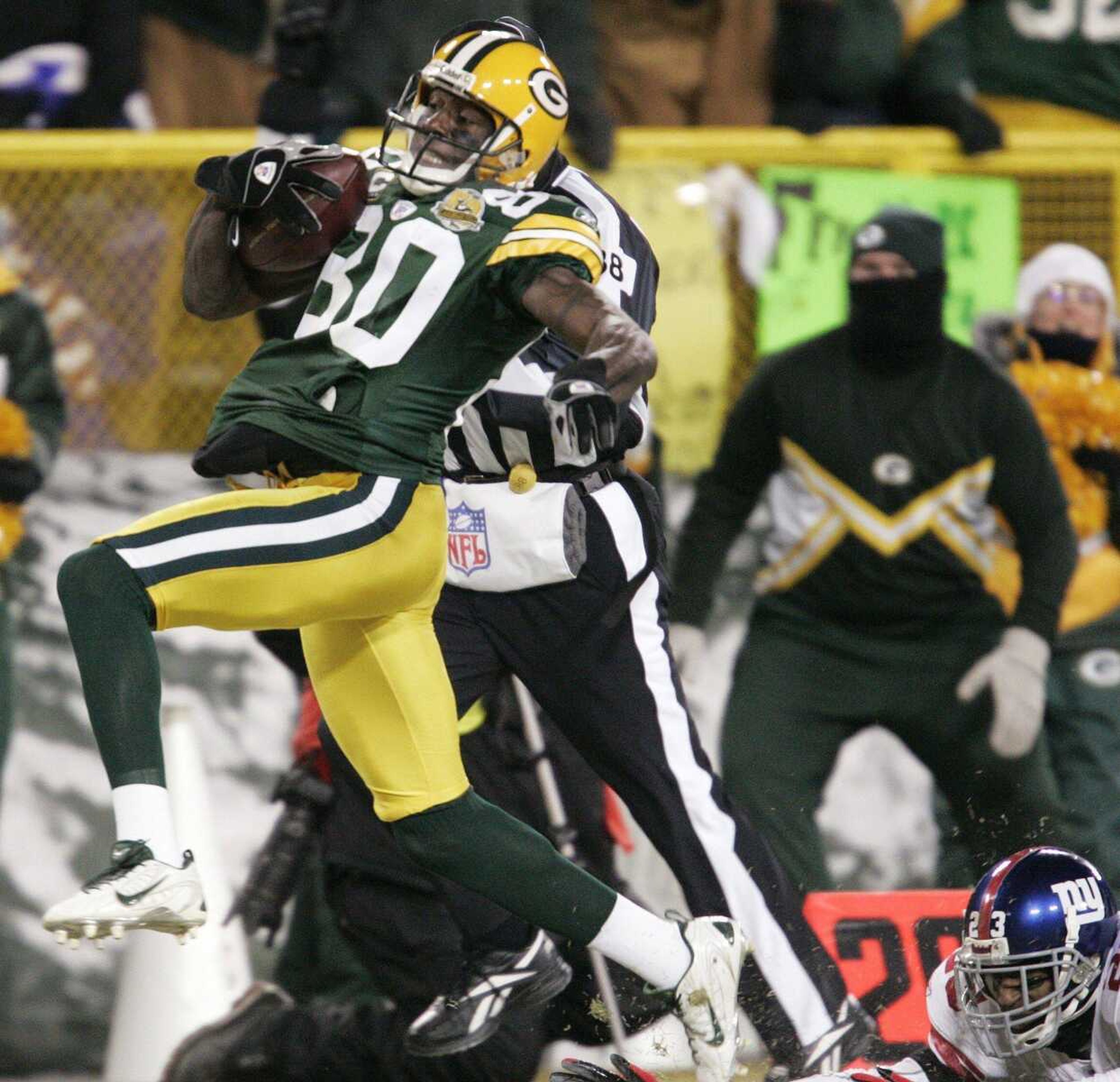 Green Bay Packers wide receiver Donald Driver (80) runs from New York Giants cornerback Corey Webster, bottom right, on a first-half touchdown reception in the NFC Championship football game Sunday, Jan. 20, 2008, in Green Bay, Wis. (AP Photo/Mike Roemer)