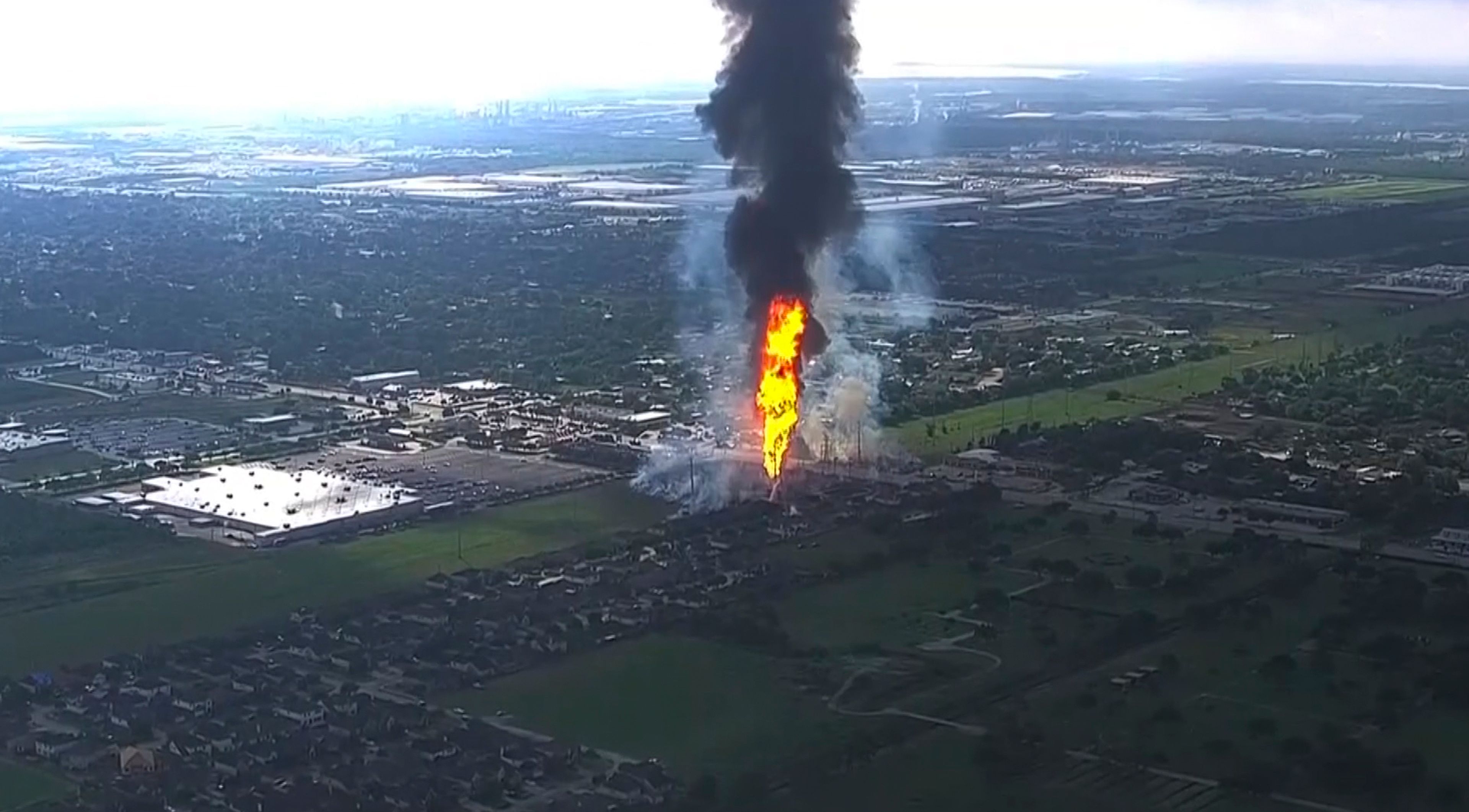 A pipeline fire in La Porte, Texas, sparks grass fires and burns power poles on Monday, Sept. 16, 2024, forcing people in the surrounding neighborhood to evacuate. (KTRK via AP)