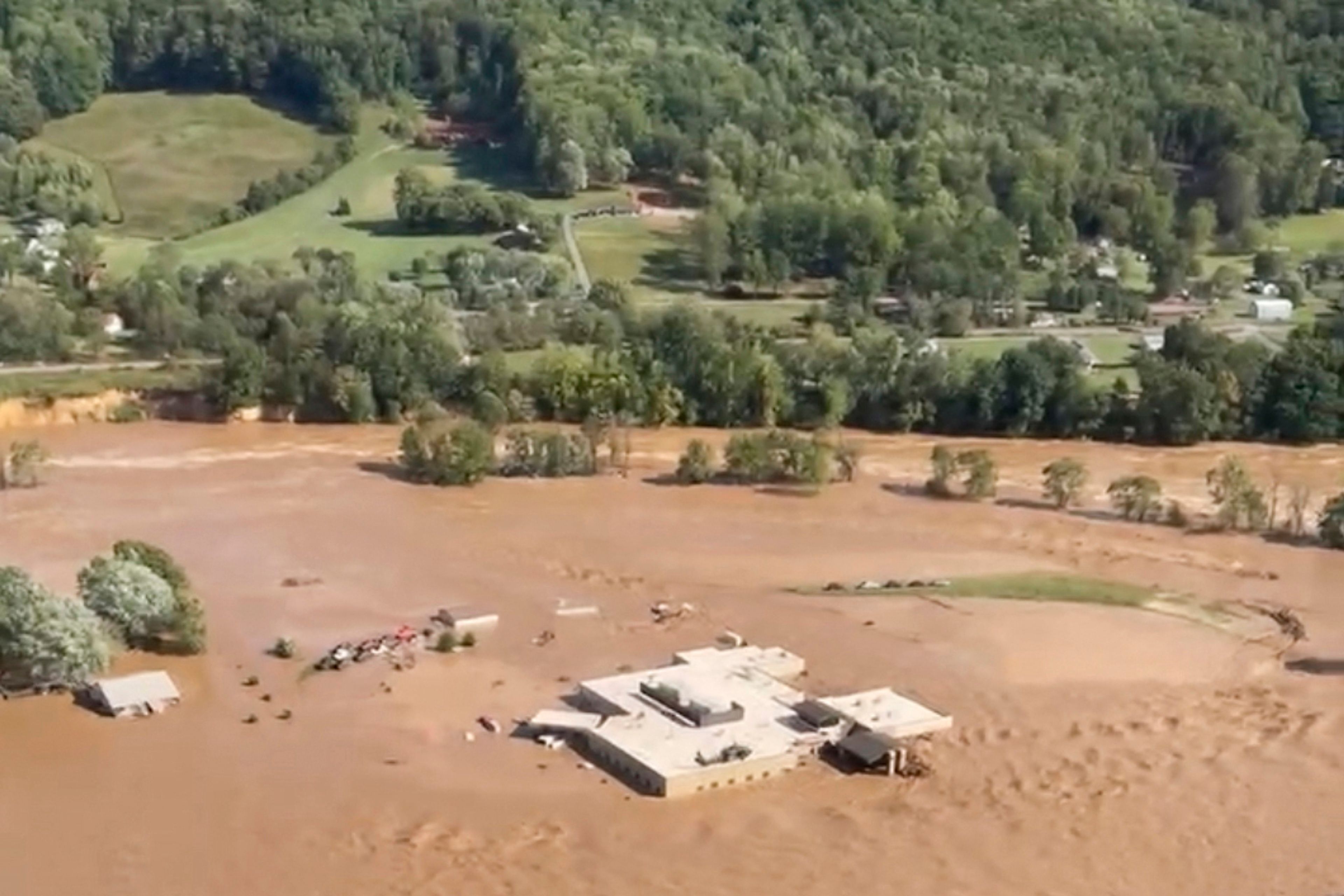 This image taken from video from the Tennessee Emergency Management Agency shows a helicopter on the roof of Unicoi County Hospital in Erwin, Tenn., where patients and staff had to be rescued from after the Nolichucky River flooded and surrounded the building from Hurricane Helene, Friday, Sept. 27, 2024. (Tennessee Emergency Management Agency via AP)