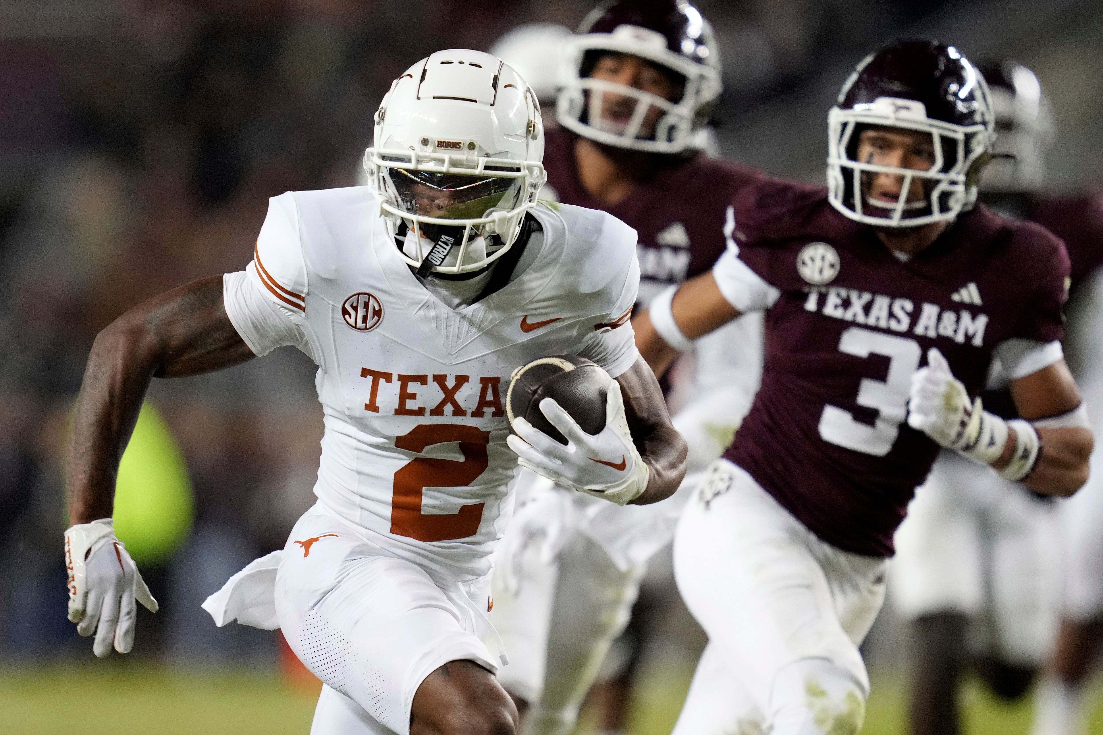 Texas wide receiver Matthew Golden (2) runs for yards after a catch against Texas A&M during the second half of an NCAA college football game Saturday, Nov. 30, 2024, in College Station, Texas. (AP Photo/Sam Craft)