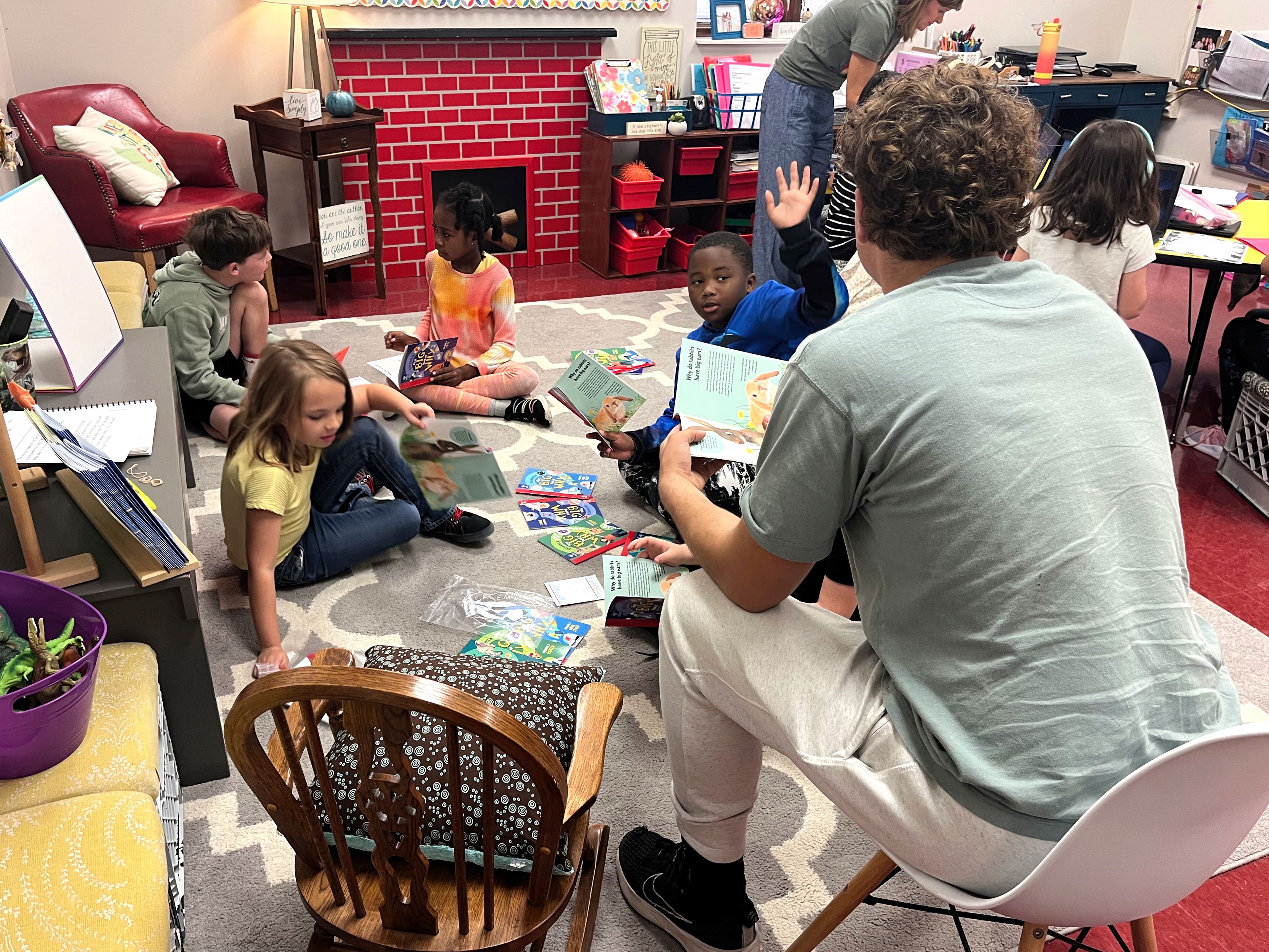 Blanchard Elementary students Violet Clark, Carsen Ellis, Myra Young and Isaiah Hamilton listen as Cape Girardeau Central High School senior Nate Roth reads to them on Tuesday as part of Chick-fil-A Leader Academy's 1 Million Book Giveaway. 