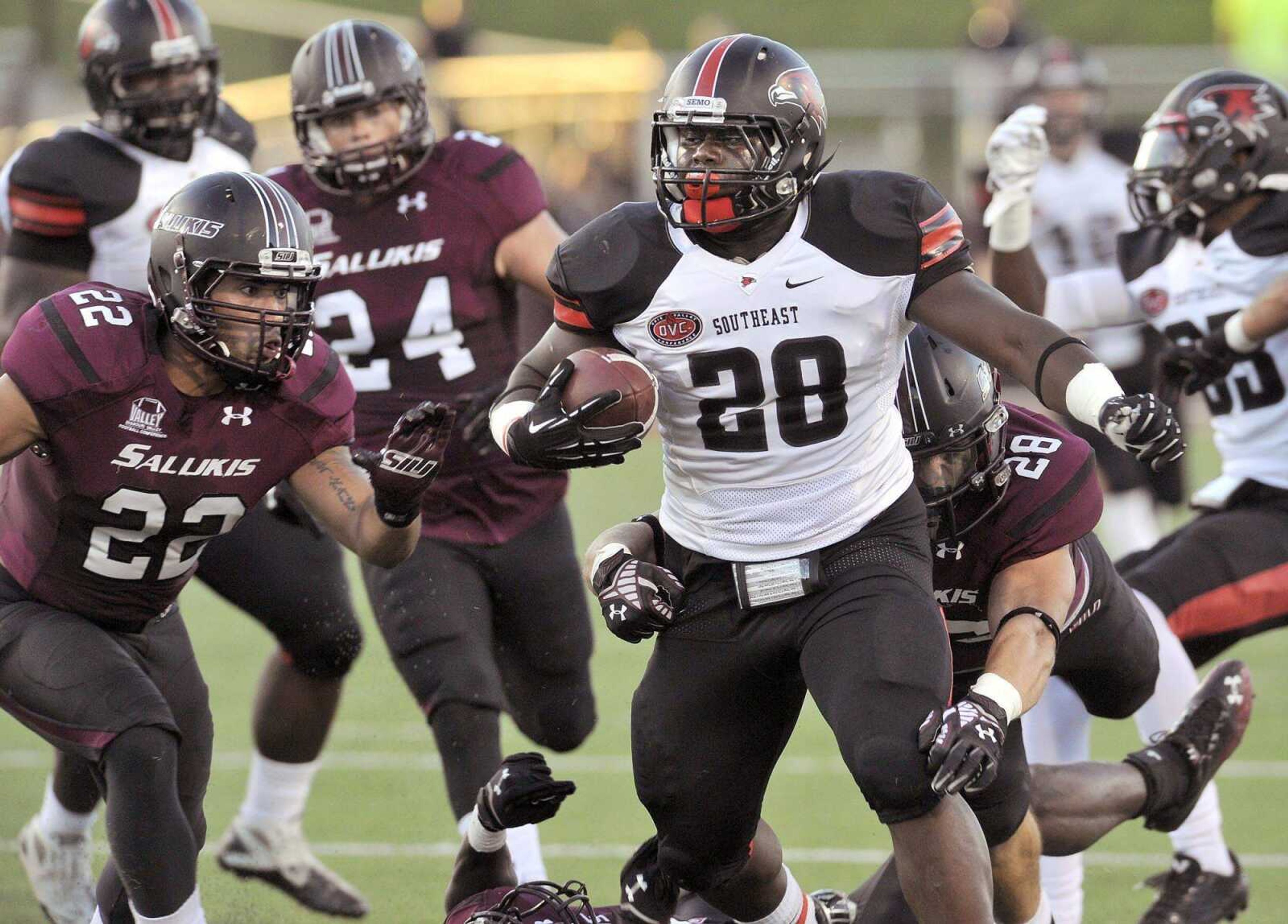 Southeast Missouri State running back Lewis Washington carries past Southern Illinois' Jordan Poole with Chase Allen ready to tackle him during the first quarter Saturday, Sept. 13, 2014 in Carbondale, Ill. (Fred Lynch)