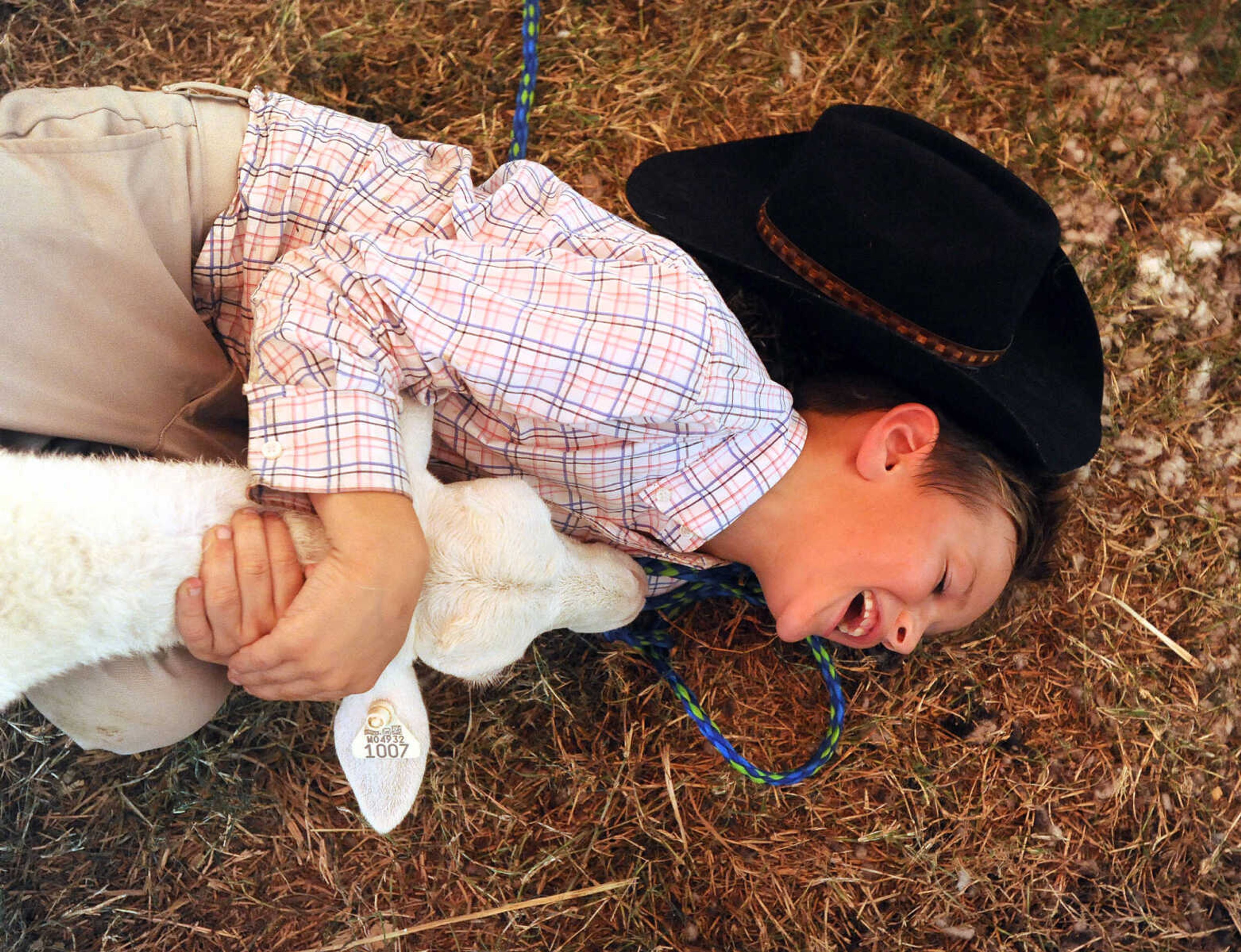 LAURA SIMON ~ lsimon@semissourian.com

Grady Ruehling holds on tight to hit black hat sheep, "Frank" as she tries to get away after her lead came off on Wednesday, Sept. 14, 2016, during the sheep judging at the SEMO District Fair at Arena Park in Cape Girardeau.